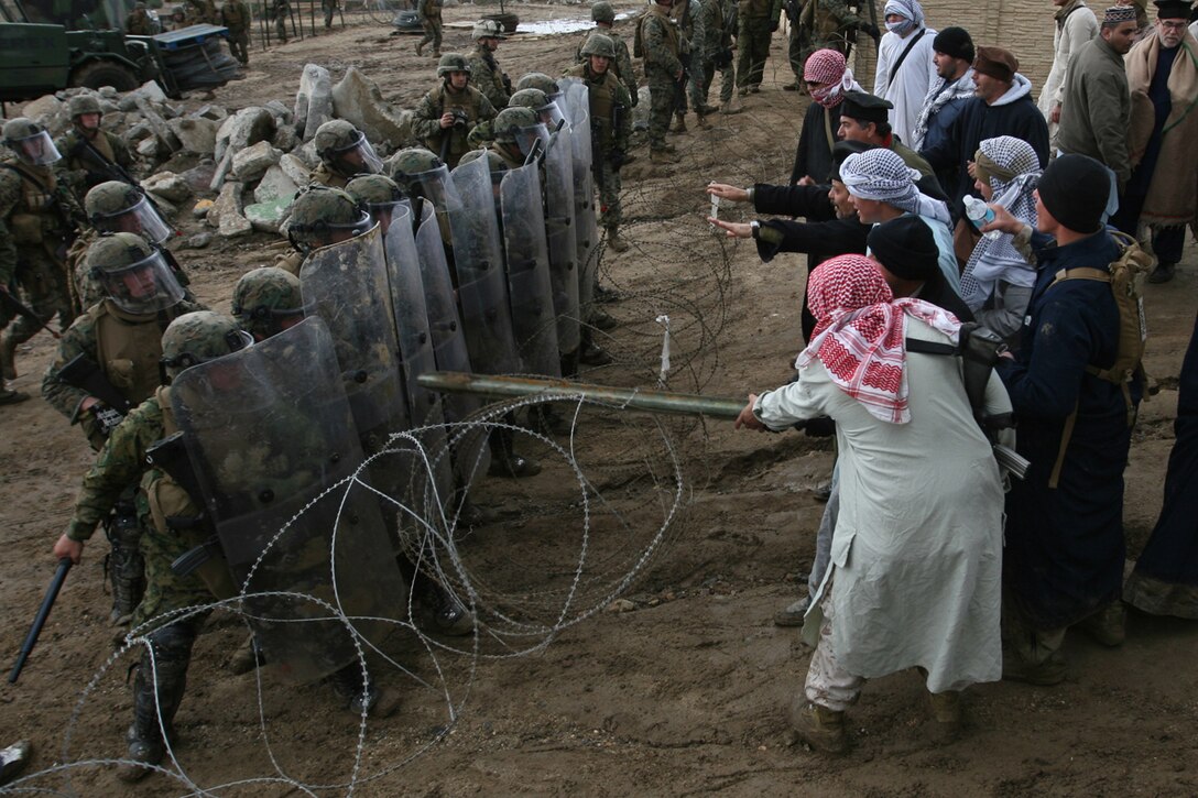 CAMP PENDLETON, Calif., (January 24, 2008) -- Marines from India Battery, Battalion Landing Team 2/5, hold back civilian role players during a humanitarian assistance operation exercise at Kilo 2 Area Combat town here. The Marines were tasked with providing security during the HAO Exercise in support of the 15th Marine Expeditionary Unit during its MEUEX. MEUEX is a series of exercises designed to prepare the 15th MEU for its upcoming planned deployment. (Official USMC Photo by Cpl Kevin N. McCall) (Released)