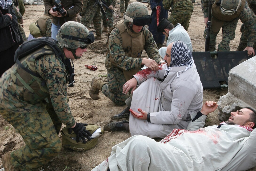 CAMP PENDLETON, Calif., (January 24, 2008) -- Navy Corpsmen from India Battery, Battalion Landing Team 2/5, treat civilians during the mass casualty evacuation exercise portion of the humanitarian assistance operation exercise at Kilo 2 Area Combat town here. The Marines were tasked with providing security during the HAO Exercise in support of the 15th Marine Expeditionary Unit during its MEUEX. MEUEX is a series of exercises designed to prepare the 15th MEU for its upcoming planned deployment. (Official USMC Photo by Cpl Kevin N. McCall) (Released)
