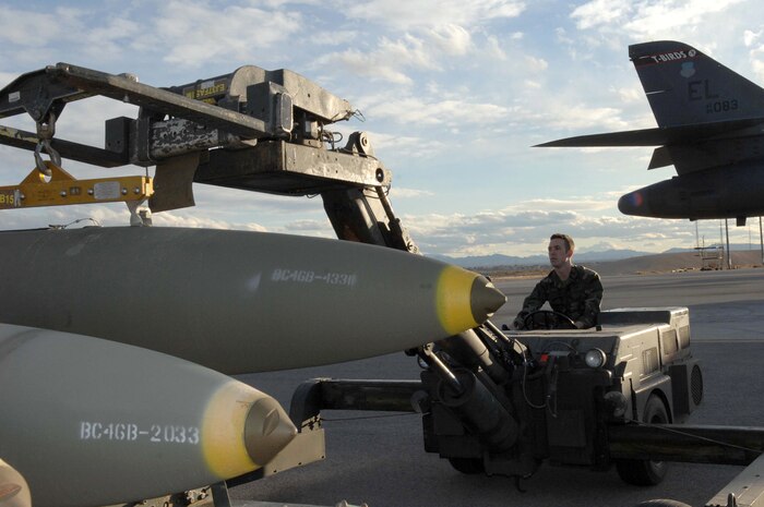 NELLIS AIR FORCE BASE, Nev.—Staff Sgt. Marcus Ochoa, a weapons team chief with the 28th Aircraft Maintenance Squadron, Ellsworth AFB, S.D., utilizes a weapons jammer to place an MK-84 bomb on a bomb rack here Jan. 24. The B-1 bombers, assigned to the 34th Bomb Squadron, Ellsworth AFB, S.D., are flying air interdiction sorties during Red Flag 8-2.1, which is a multi-national exercise training pilots in the world’s most realistic combat scenarios. The experience gained during the exercise is vital to the survival of pilots in combat. (U.S. Air Force photo by Senior Airman Larry E. Reid Jr.)