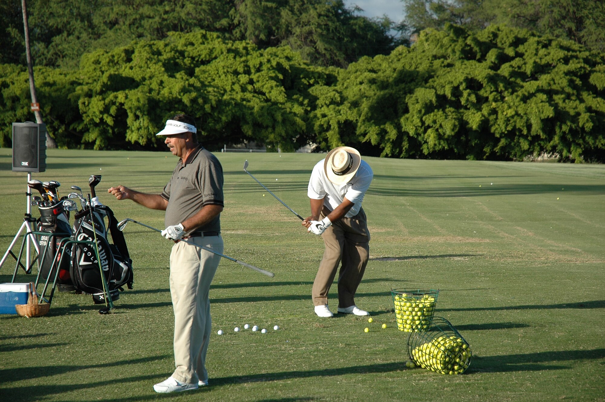 Part of any golf clinic is showing how it’s done. PGA Champions Tour player, Jim Thorpe demonstrates proper form while  Brad Bryant, in front, provides feedback to the audience at Mamala Bay Golf Course Tuesday about correct position before impact and how to get there.  (Photo by Tom Willa)  