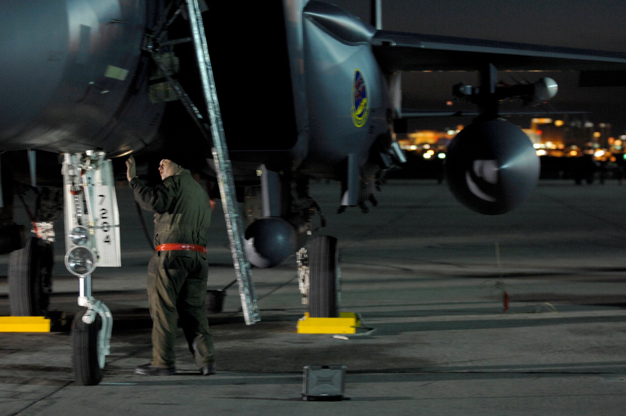 NELLIS AIR FORCE BASE, Nev.—Staff Sgt. Jesse Poynter, a crew chief from the 366th Fighter Maintenance Squadron, Mountain Home AFB, Idaho, performs a post-flight inspection on his F-15E Strike Eagle after a mission during Red Flag 8-2.1, here Jan. 23. Red Flag is a two-week long multi-national exercise training pilots in the world’s most realistic combat scenarios. The experience gained during the exercise is vital to the survival of pilots in combat. (U.S. Air Force photo by Master Sgt. Robert W. Valenca)