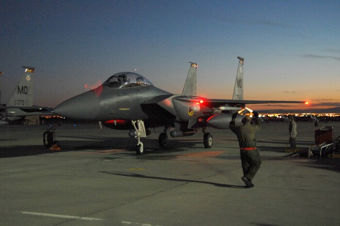 NELLIS AIR FORCE BASE, Nev.—Staff Sgt. Jesse Poynter, a crew chief from the 366th Fighter Maintenance Squadron, Mountain Home AFB, Idaho, taxis in an F-15E Strike Eagle after a mission during Red Flag 8-2.1, here Jan. 23. Red Flag is a two-week long multi-national exercise training pilots in the world’s most realistic combat scenarios. The experience gained during the exercise is vital to the survival of pilots in combat. (U.S. Air Force photo by Master Sgt. Robert W. Valenca)