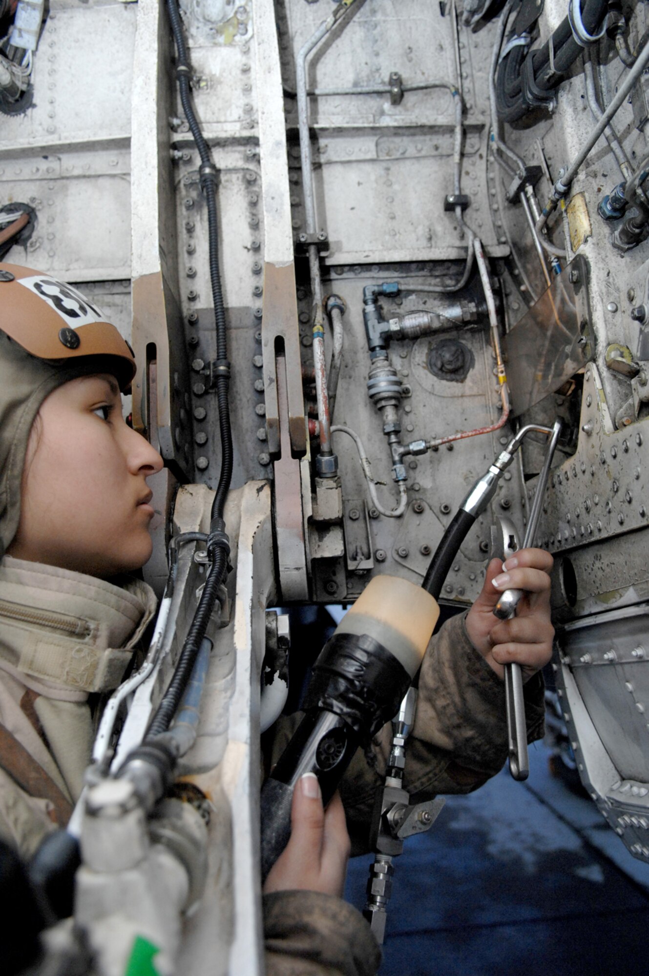NELLIS AIR FORCE BASE, Nev.—Airmen Apprentice Karen Gonzalez, 134th Electronic Attack Squadron, Naval Air Station Whidbey Island, Wash., services the nitrogen unit on an EA-6B Prowler before a night mission here Jan. 23. Airmen Gonzalez is at Nellis with her unit participating in Red Flag 8-2.1, which is a multi-national exercise training pilots in the world’s most realistic combat scenarios. The experience gained during the exercise is vital to the survival of pilots in combat. (U.S. Air Force Photo by Master Sgt Robert W. Valenca)