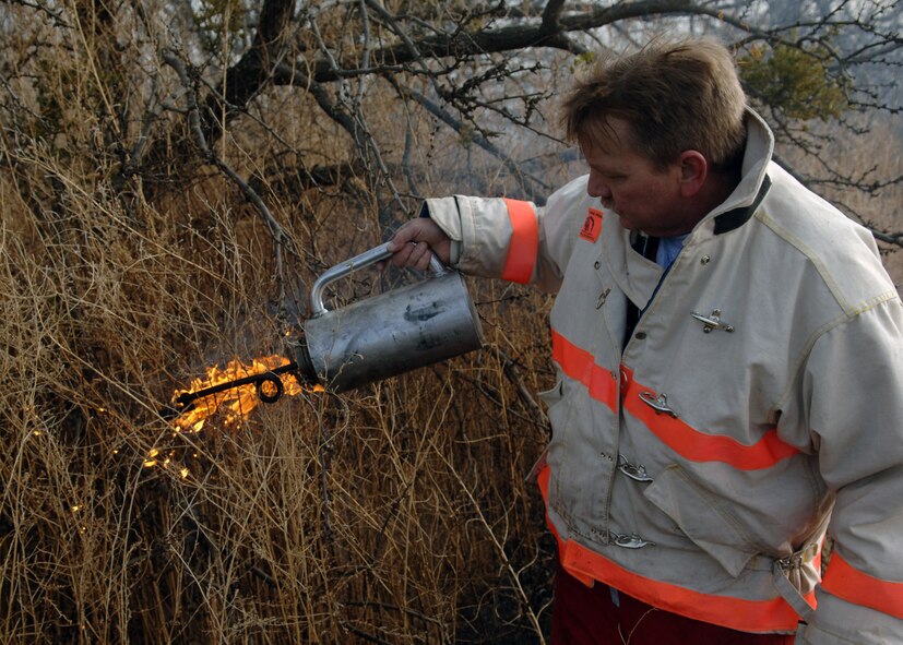 DYESS AFB, Texas -- Deputy Fire Chief Mr. Floyd Jones lights up an acre of dry grass, Jan 17. The Dyess Fire Department initiates prescribed burns such as these in order to prevent wildfires and rebuild wildlife habitats. (U.S. Air Force photo by Airman 1st Class Micheal Breaux)
