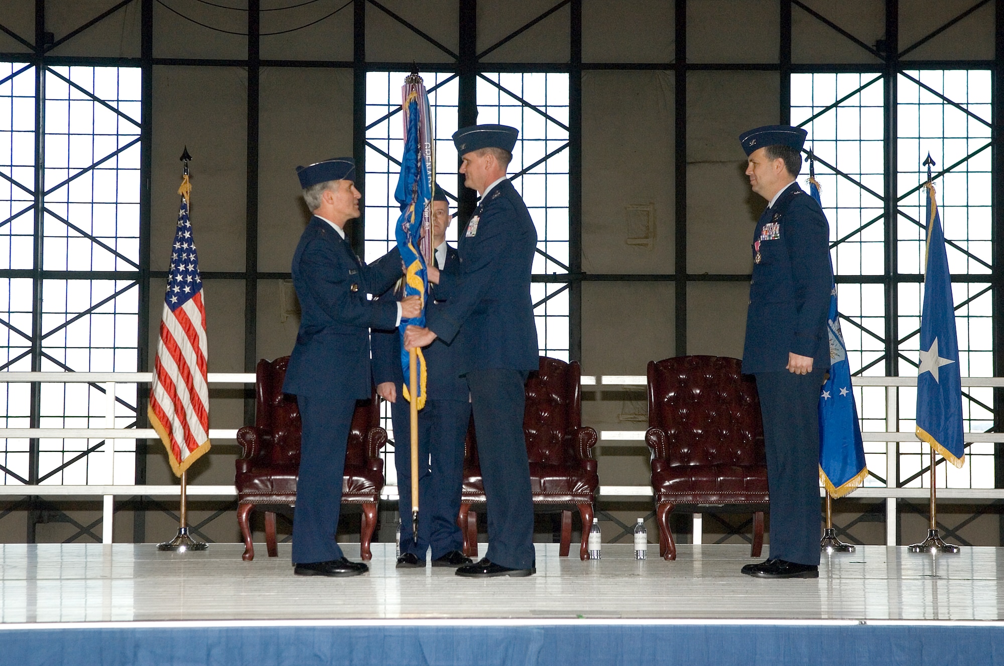 Maj. Gen. James Hawkins, left, 18th Air Force commander, presents Col. Jeffrey Stephenson the 62nd Airlift Wing flag at the change-of-command ceremony Wednesday at Hangar 4.