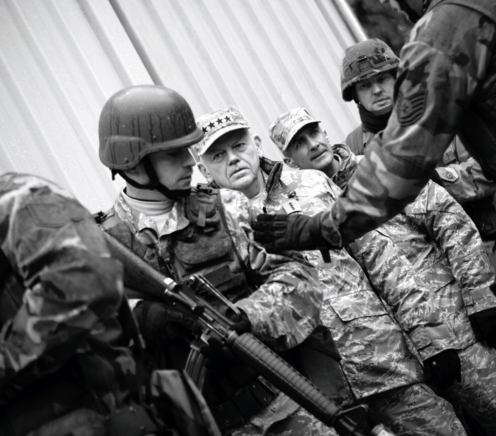 Gen. Arthur Lichte, Air Mobility Command commander from Scott Air Force Base, Ill., and Chief Master Sgt. Joseph Barron, AMC command chief, learn about tactics in military operations in urban terrain during a practice scenario for the training at Naval Air Engineering Station Lakehurst, N.J., Jan. 22.  The effort was part of General Lichte's official visit to the U.S. Air Force Expeditionary Center, located at Fort Dix, N.J., and to the Center's Exercise Eagle Flag which is conducted at NAES Lakehurst.  (U.S. Air Force Photo/Master Sgt. Bob Lorusso)
