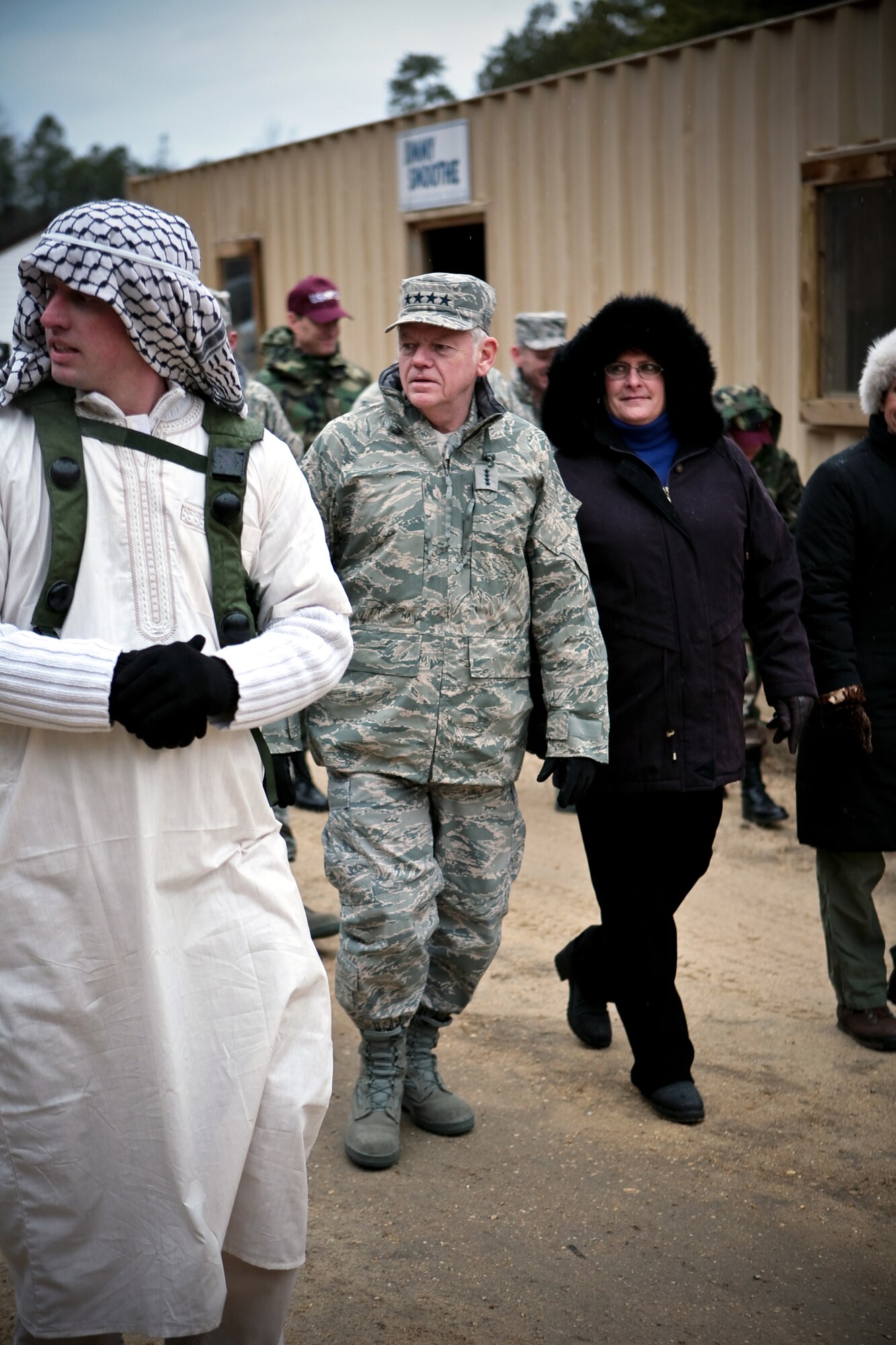 Tech. Sgt. Richard Oliver, U.S. Air Force Expeditionary Center's 421st Combat Training Squadron, talks with Gen. Arthur Lichte, Air Mobility Command commander, his wife Chris Lichte, and others about the Center's training for Air Force Exercise Eagle Flag during General Lichte's visit to the Center and Eagle Flag Jan. 22 on Fort Dix and Naval Air Engineering Station Lakehurst, N.J.  The official visit by the mobility commander provided a full spectrum of the USAF EC's capabilities in training, innovation and facilities. Sergeant Oliver plays the role of "chieftain" in the exercise.  (U.S. Air Force Photo/Master Sgt. Bob Lorusso)