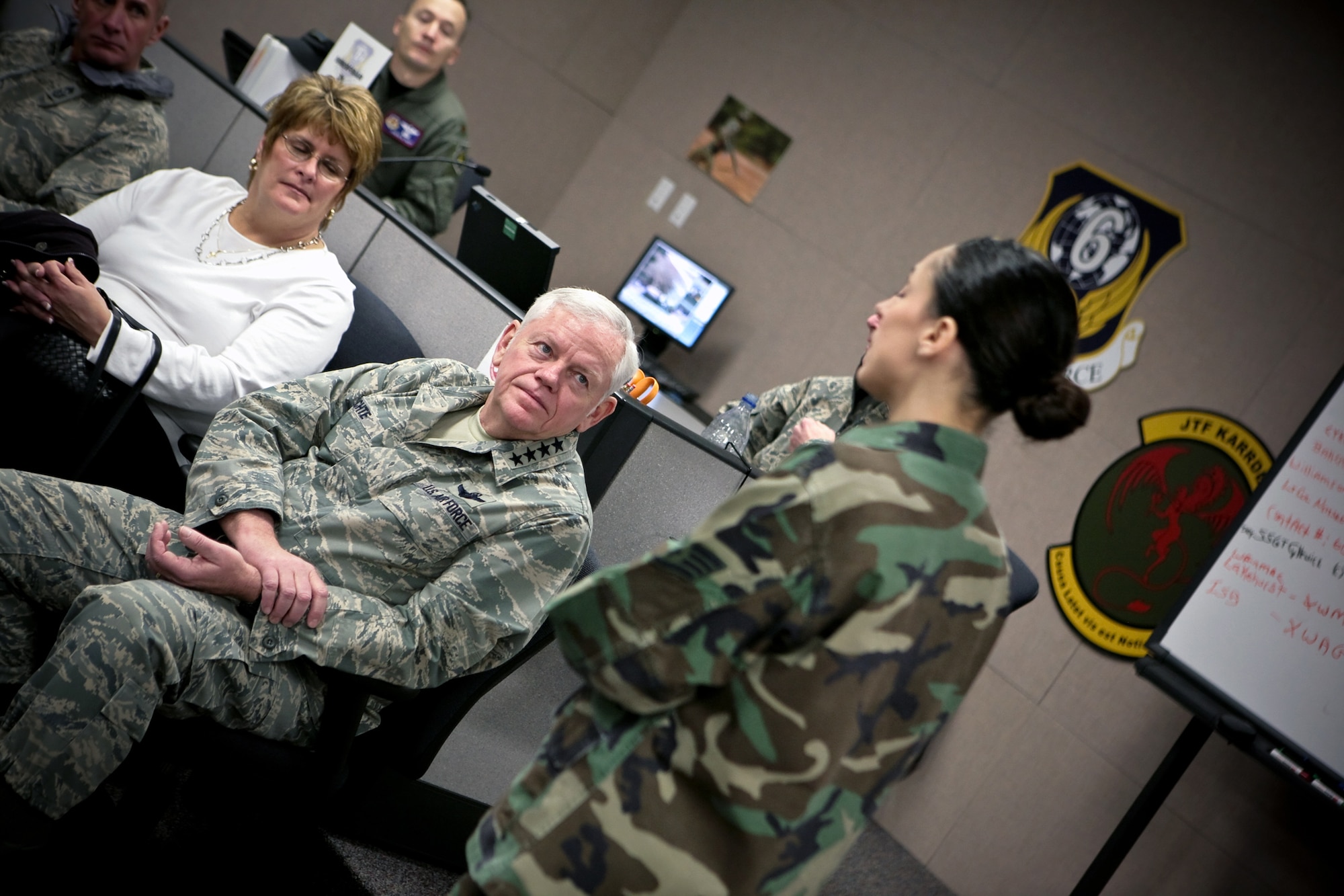Gen. Arthur Lichte, Air Mobility Command commander from Scott Air Force Base, Il.., his wife Chris Lichte, and others listen to Staff Sgt. Jacqueline Baker of the U.S. Air Force Expeditionary Center's 421st Combat Training Squadron discuss how her unit uses an Air Force staff of role players to help coordinate Air Force Exercise Eagle Flag Jan. 22 on the campus of the Center on Fort Dix, N.J.  (U.S. Air Force Photo/Master Sgt. Bob Lorusso)
