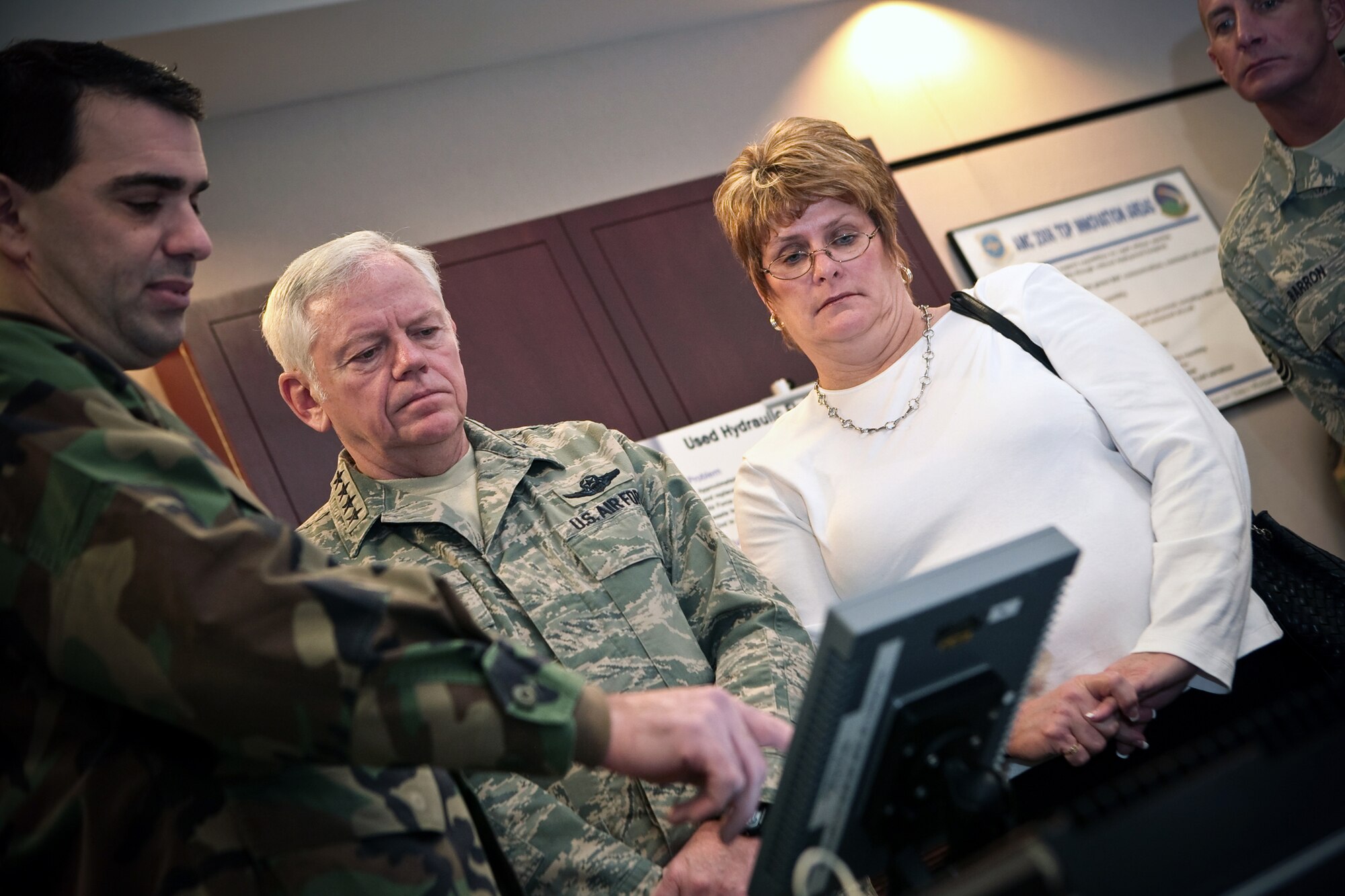 Maj. Dan Adler, U.S. Air Force Expeditionary Center Concepts Demonstration Program, shows Gen. Arthur Lichte, Air Mobility Command commander, his wife Chris Lichte, and Chief Master Sgt. Jospeh Barron, AMC command chief, one of the air mobility improvement initiatives done by the program Jan. 22 at Fort Dix, N.J.  The effort was part of General Lichte's firt official visit to the USAF EC.  (U.S. Air Force Photo/Master Sgt. Bob Lorusso()