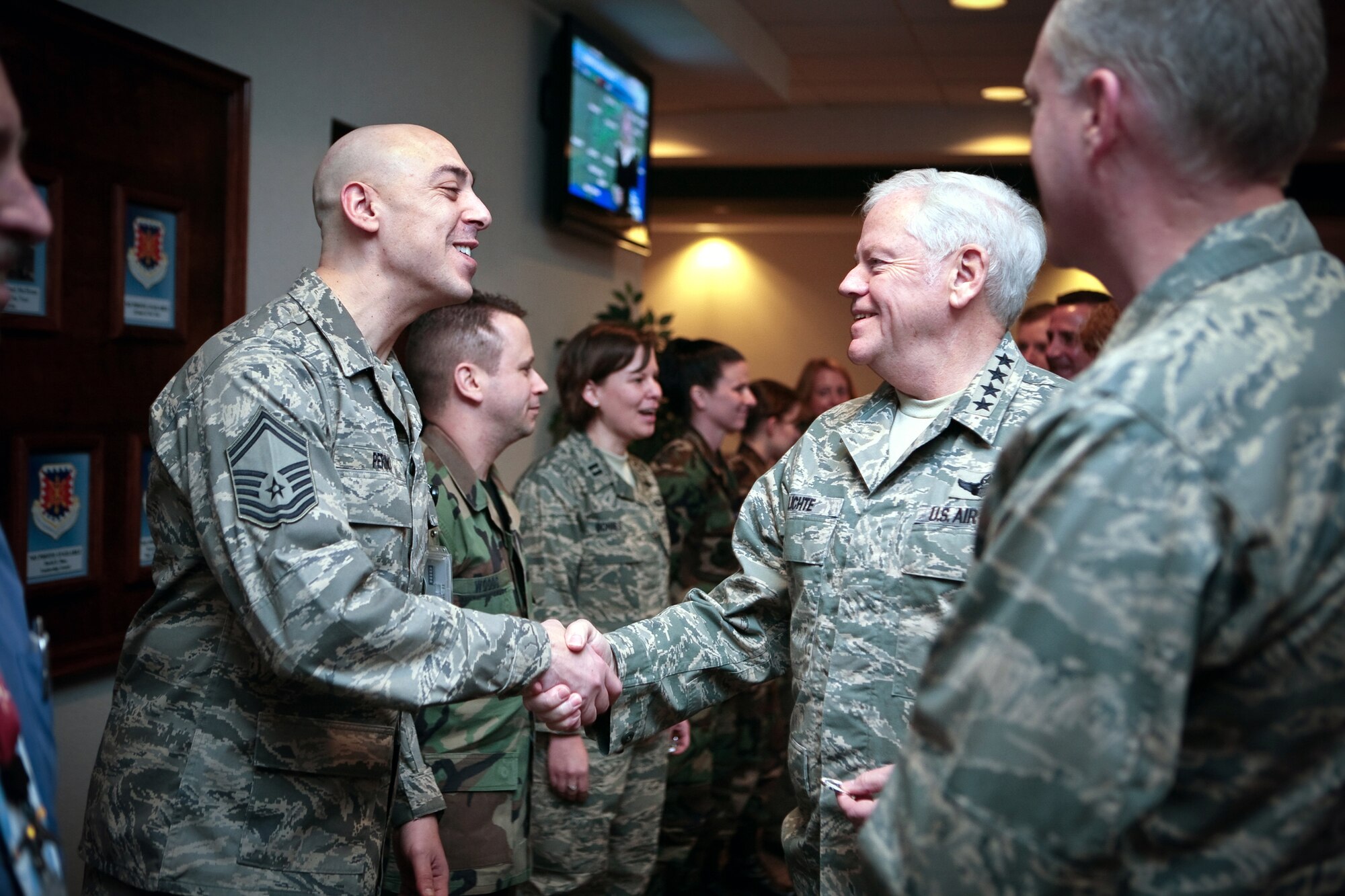 Gen. Arthur Lichte, Air Mobility Command commander at Scott Air Force Base, Ill., shakes hands with Senior Master Sgt. Dominic Perino of the U.S. Air Force Expeditionary Center's Concepts Demonstration Program while presenting a commander's coin Jan. 22 at the Center on Fort Dix, N.J.  General Lichte was making his first official visit to the USAF EC.  (U.S. Air Force Photo/Master Sgt. Bob Lorusso)