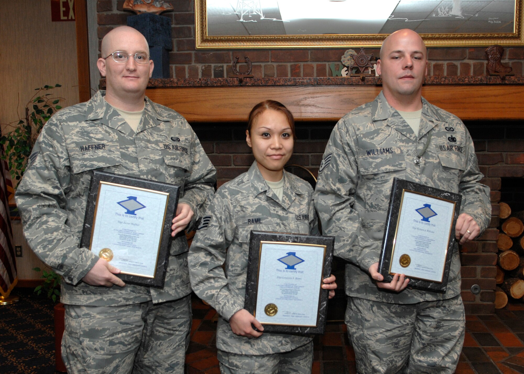 CANNON AIR FORCE BASE, N.M. - (left to right) Staff Sgt. Jarret Haffner, 27th Special Operations Maintenance Operations Squadron, Staff Sgt. Lovelynn Ramil, 27th Special Operations Comptroller Squadron, and Staff Sgt. Richard Williams, 27th Special Operations Wing Public Affairs, present their Diamond Sharp award. The Diamond Sharp awards ceremony was held at the Pecos Trail Dining Facility Jan. 25. (U.S. Air Force photo by Airman 1st Class Erik Cardenas)