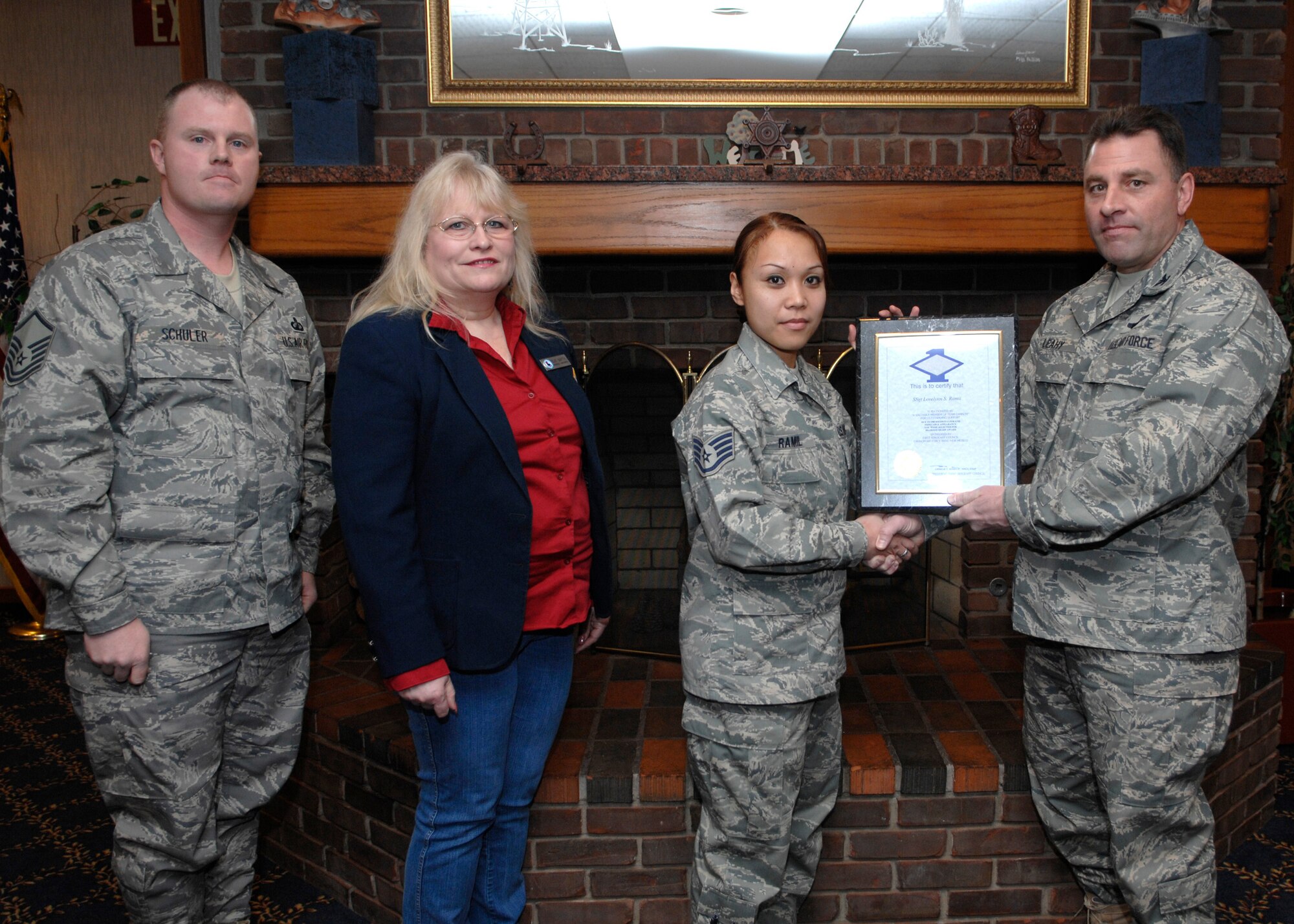 CANNON AIR FORCE BASE, N.M. - Staff Sgt. Lovelynn Ramil, 27th Special Operations Comptroller Squadron, receives the Diamond Sharp award presented by Col. Timothy Leahy, 27th Special Operations Wing commander, and Master Sgt. Russell Schuler, 27 SOCPTS first sergeant. Diamond Sharp was sponsored by the Defense Commissary Agency, represented by Ms. Sue Smith, and took place at the Pecos Trail Dining Facility. (U.S. Air Force photo by Airman 1st Class Erik Cardenas)