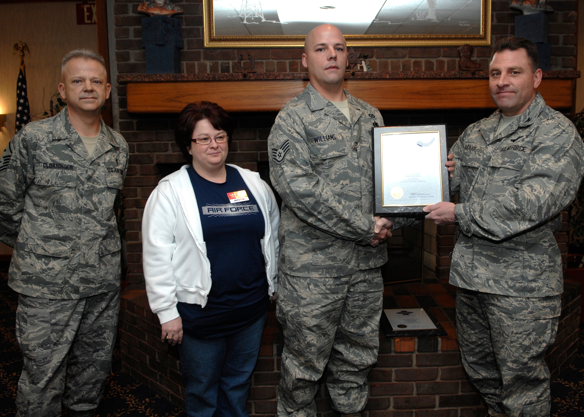 CANNON AIR FORCE BASE, N.M. - Staff Sgt. Richard Williams, 27th Special Operations Wing Public Affairs, receives the Diamond Sharp award presented by Col. Timothy Leahy, 27 SOW commander, and Master Sgt. Fred Cloaninger, 27 SOW and 27 Special Operations Mission Support Squadron first sergeant. Diamond Sharp is sponsored by AAFES Coupons, represented by Ms. Jessica Foster, and took place at the Pecos Trail Dining Facility Jan. 25. (U.S. Air Force photo by Airman 1st Class Erik Cardenas)
