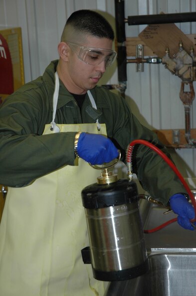 MINOT AIR FORCE BASE, N.D. -- Airman 1st Class Joel Mendoza, a pest management apprentice with the 5th Civil Engineering Squadron, readies a pesticide sprayer at the entomology shop here Jan. 25. The spray prevents target insects from maturing to adulthood, leaving them incapable of reproducing.  (U.S. Air Force photo by Staff Sgt. Thomas Dow)