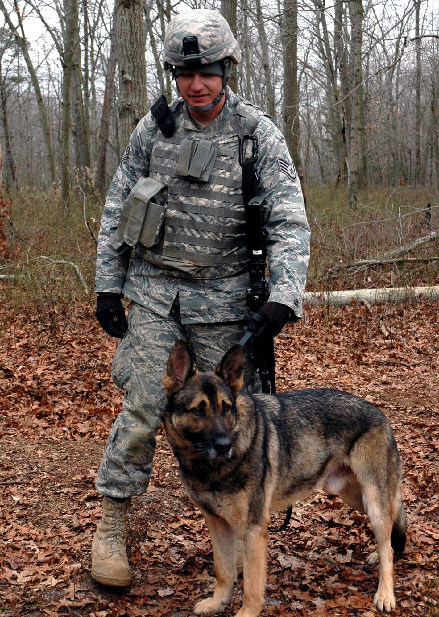 Staff Sgt. Jason Hanisko and his military working dog Arek, both students in the U.S. Air Force Expeditionary Center's Phoenix Warrior Training Course K-9 track, take a break from training on a range on Fort Dix, N.J., Jan. 22.  Sergeant Hanisko and Arek are from the 75th Security Forces Squadron at Hill Air Force Base, Utah.  (U.S. Air Force Photo/Tech. Sgt. Scott T. Sturkol)