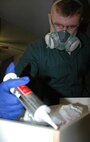 MINOT AIR FORCE BASE, N.D. – Senior Airman Alex Hooper, a pest management journeyman with the 5th Civil Engineering Squadron, applies a gel-like bait in a dorm room drawer here Jan. 25.  Once the insects consume the bait, they are poisoned and quickly die. (U.S. Air Force photo by Staff Sgt. Thomas Dow)