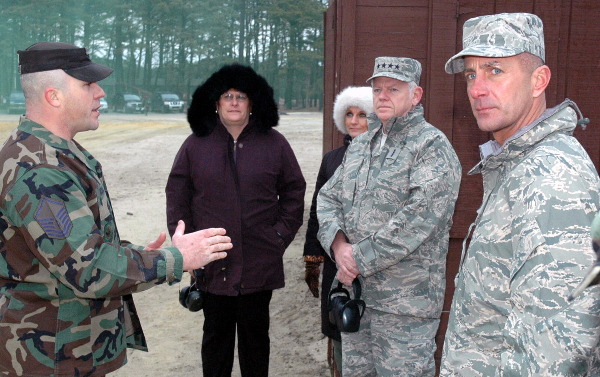 Master Sgt. Mike McHone, U.S. Air Force Expeditionary Center's 421st Combat Training Squadron, talks with Gen. Arthur Lichte, Air Mobility Command commander, his wife Chris Lichte, and Chief Master Sgt. Jospeph Barron, AMC command chief, about the Center's training for security forces during General Lichte's visit to the Center Jan. 22 on Fort Dix, N.J.  The official visit by the mobility commander provided a full spectrum of the USAF EC's capabilities in training, innovation and facilities. (U.S. Air Force Photo/Tech. Sgt. Scott T. Sturkol)