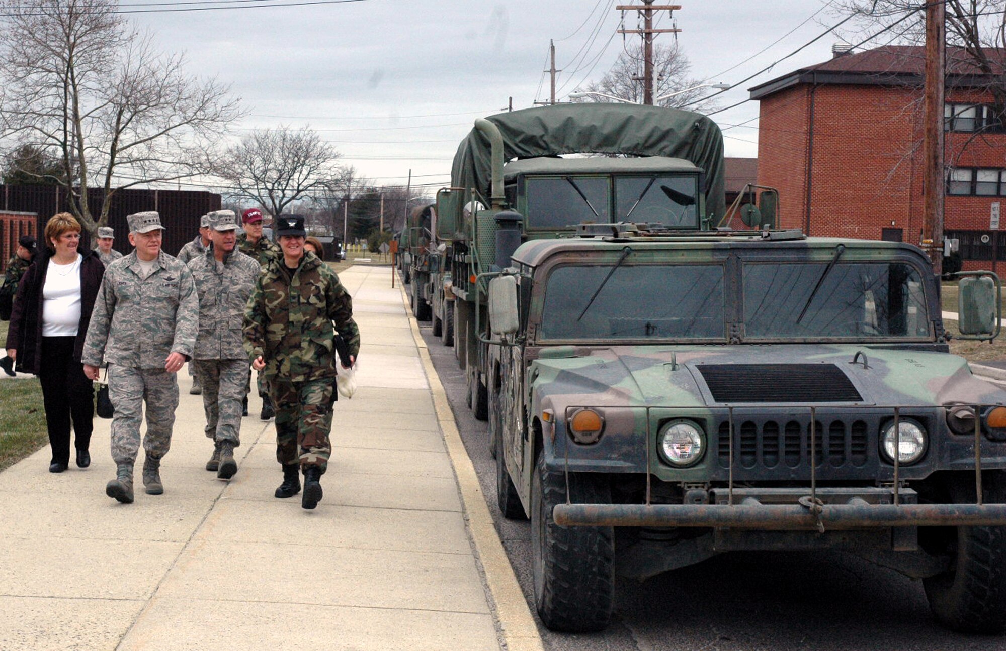 Col. Jennifer Pickett, commandant of the U.S. Air Force Expeditionary Center's Expeditionary Operations School, leads Maj. Gen. Kip Self, USAF EC commander, Gen. Arthur Lichte, Air Mobility Command commander, Mrs. Chris Lichte, and others past a group of military tactical vehicles during an official visit to the Center Jan. 22 by General Lichte on Fort Dix, N.J.   The official visit by the mobility commander provided a full spectrum of the USAF EC's capabilities in training, innovation and facilities.  (U.S. Air Force Photo/Tech. Sgt. Scott T. Sturkol) 