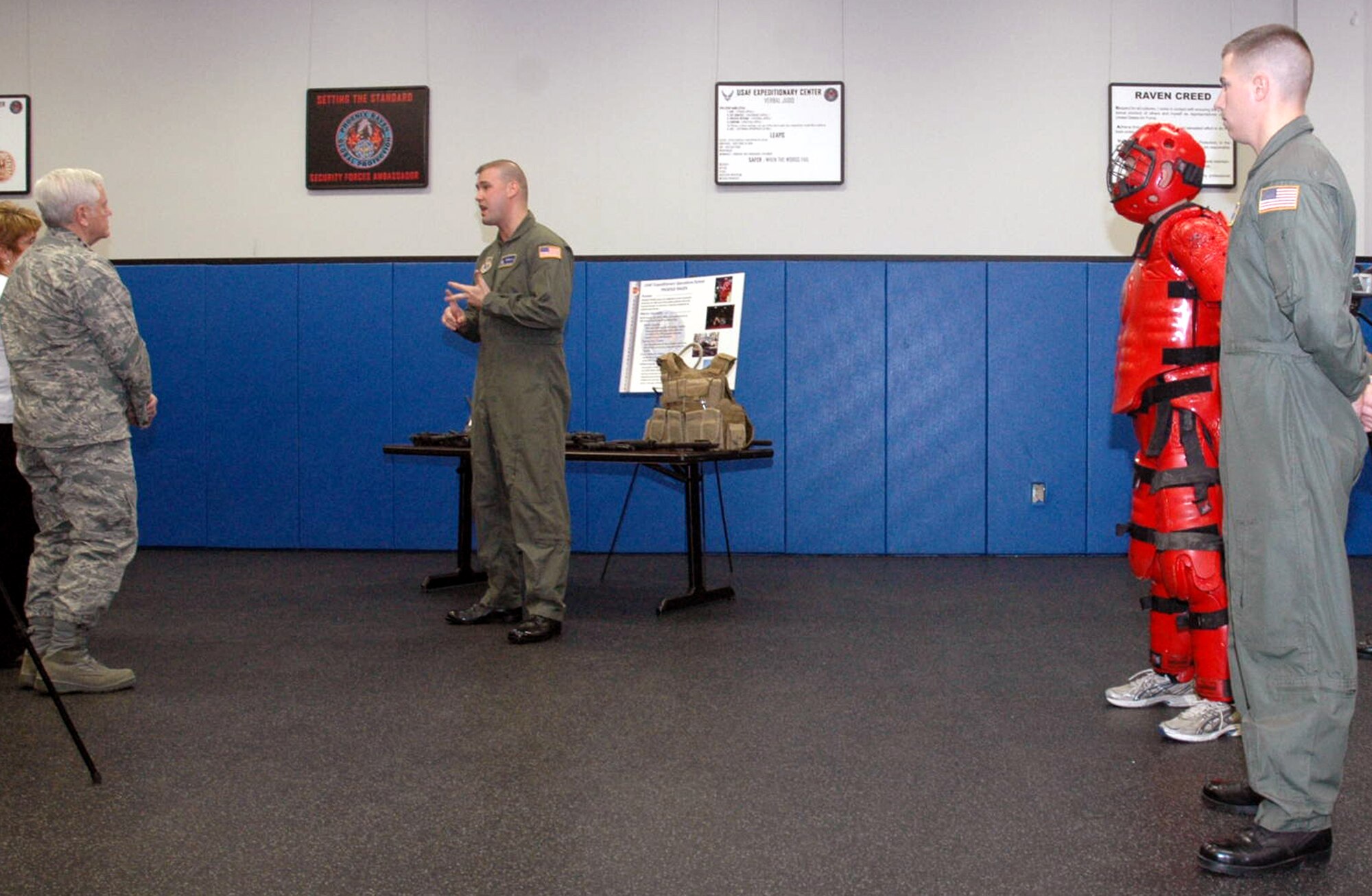 Tech. Sgt. Daniel Koenigsmann, U.S. Air Force Expeditionary Center's 421st Combat Training Squadron, talks to Gen. Arthur Lichte, Air Mobility Command commander and his wife Chris Lichte, about the Phoenix Raven training program during General Lichte's visit to the Center Jan. 22 on Fort Dix, N.J.  The official visit by the mobility commander provided a full spectrum of the USAF EC's capabilities in training, innovation and facilities.  (U.S. Air Force Photo/Tech. Sgt. Scott T. Sturkol)