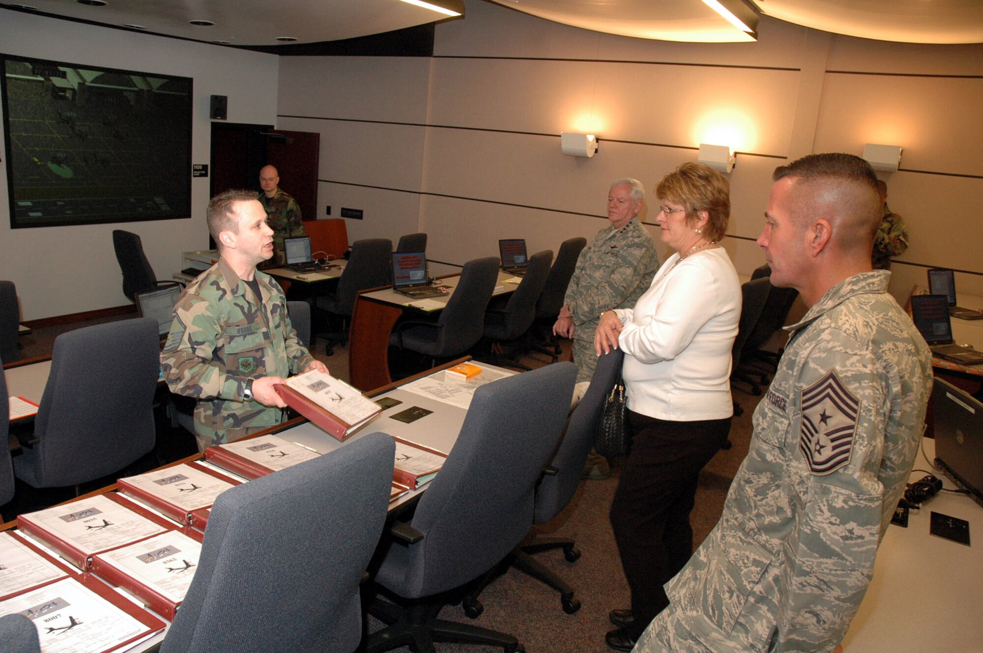 Master Sgt. Richard Woods, U.S. Air Force Expeditionary Center's Mobility Operations School, shows Gen. Arthur Lichte, Air Mobility Command commander, his wife Chris Lichte, and Chief Master Sgt. Joseph Barron, AMC command chief, one of the Center's newest training tools -- the Aircraft Maintenance Production Simulator -- during General Lichte's visit to the Center Jan. 22 on Fort Dix, N.J.  The official visit by the mobility commander provided a full spectrum of the USAF EC's capabilities in training, innovation and facilities.  (U.S. Air Force Photo/Tech. Sgt. Scott T. Sturkol)
