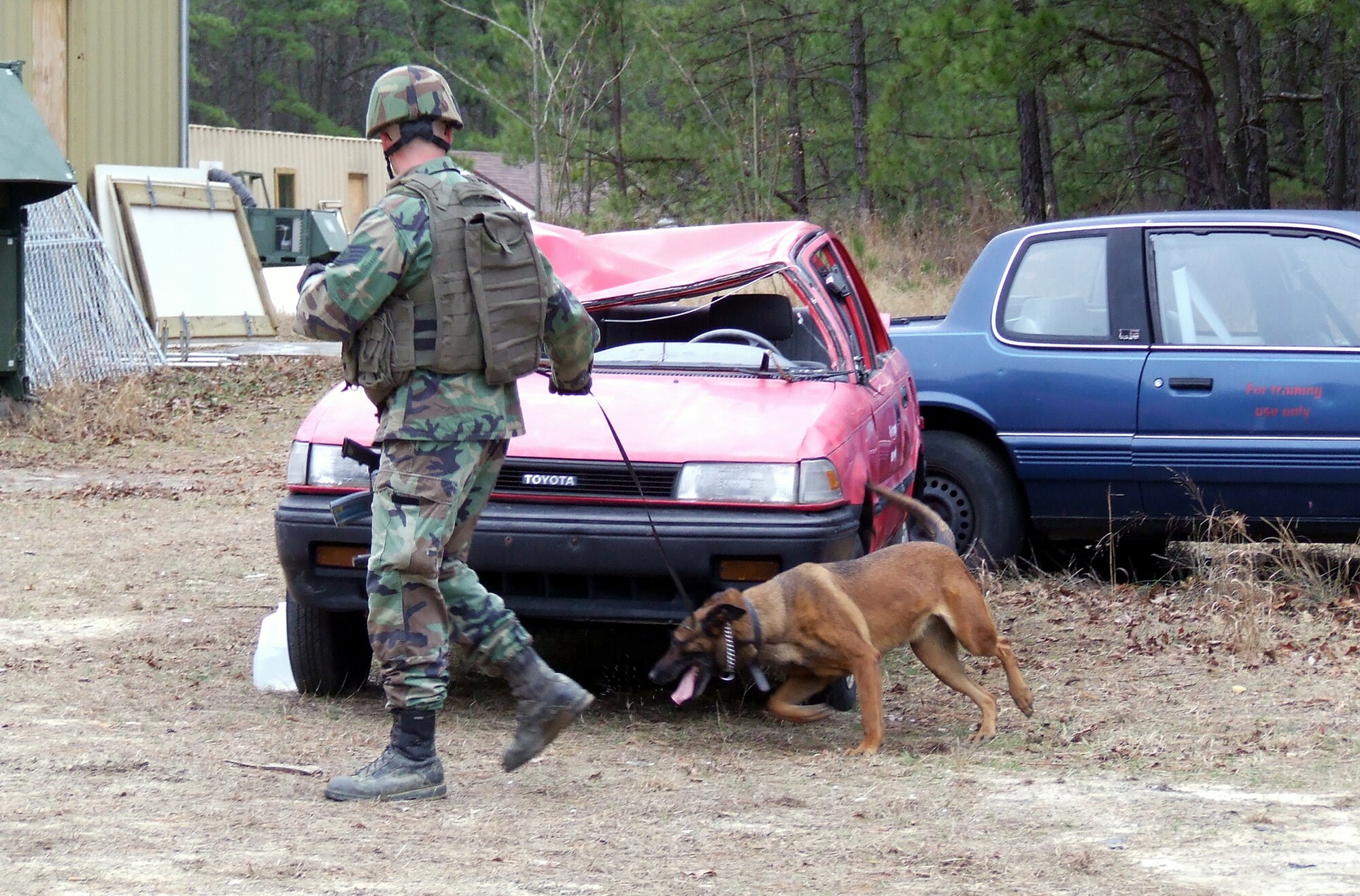 Staff Sgt. Thomas Meador and his military working dog, Ikka, both students in the Air Force Phoenix Warrior Course 08-2 from the 437th Security Forces Squadron at Charleston Air Force Base, S.C., practice a scenario during training at Naval Air Engineering Station Lakehurst, N.J., Jan. 17.  The course is operated by the U.S. Air Force Expedtionary Center's Expeditionary Operations School and 421st Combat Training Squadron.  (U.S. Air Force Photo/Tech. Sgt. Scott T. Sturkol)