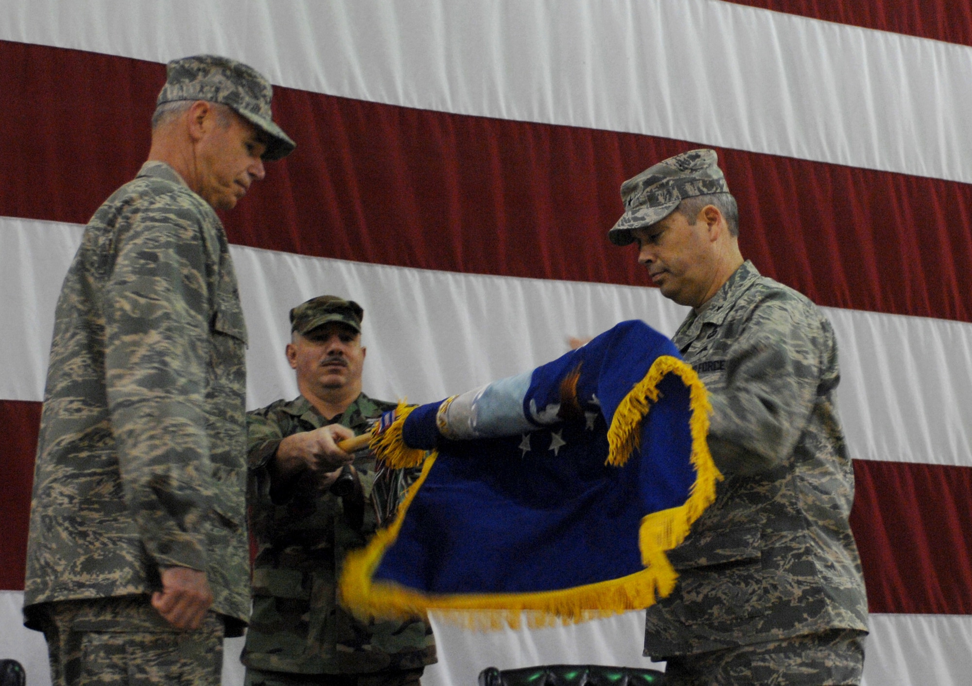 Maj. Gen. William Holland, 9th Air Force vice commander and deputy commander of U.S. Central Command Air Forces, and Brig. Gen. Michael Longoria, 93rd Air Ground Operations Wing commander, unfurl the wing's flag during an activation ceremony at Moody Air Force Base, Ga., Jan. 25. The new wing consolidates the tactical air control-party and battlefield weather specialties of the 3rd Air Support Operations Group at Fort Hood, Texas, the 18th ASOG at Pope AFB, N.C., and the specialized force protection capabilities of the 820th Security Forces Group at Moody. 
(U.S. Air Force photo by Senior Airman Angelita Lawrence)