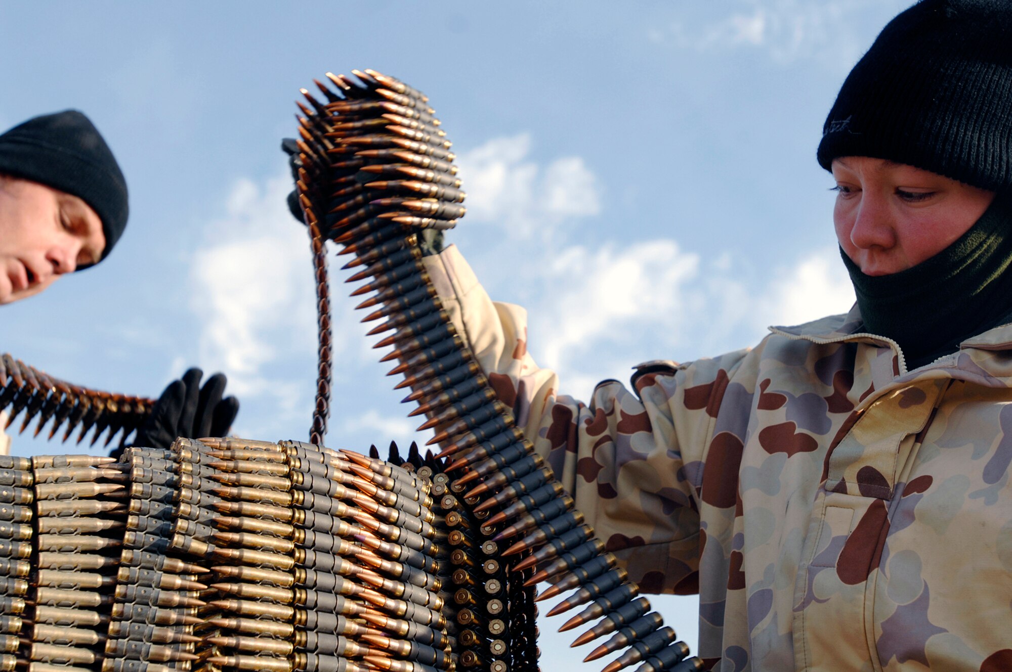 Australian Army Lance Cpls. John Bamford (left) and Natalie Pinoer place ammunition in burn bins to be destroyed during a controlled detonation Jan. 18 in Southwest Asia. The Australians worked with U.S. Air Force members from the 386th Expeditionary Civil Engineer Squadron explosive ordnance disposal flight to destroy unserviceable munitions. The corporals are with the Australian Army Force Level Logistic Asset unit. (U.S. Air Force photo/Senior Airman Patrick Dixon)