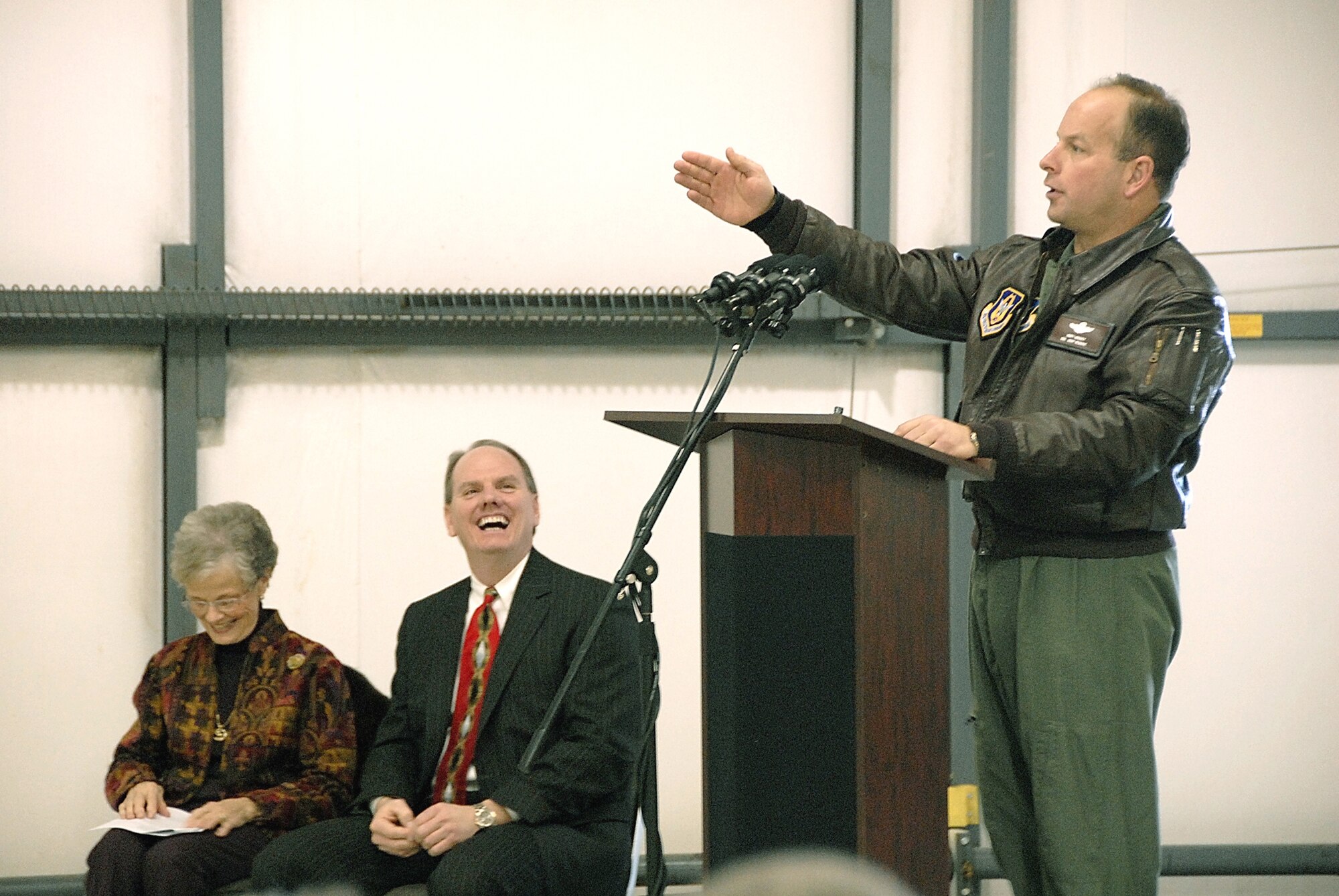 SALINA, Kan. -- Col. James Mackey, 442nd Operations Group commander, addresses the crowd at the 442nd Fighter Wing's "Thunderbolt of Salina" A-10 Thunderbolt II aircraft dedication here, Jan. 23, as Donna Vanier, Salina, Kan., resident, and Salina Mayor Alan Jilka, enjoy his remarks. The dedication ceremony was the third christening of an aircraft for Salina by Vanier and the fourth aircraft to carry the name of Salina, a central Kansas community that was once the home of the former Schilling Air Force Base, now the city's airport. Salina continues to have a military presence with the nearby Smoky Hill Air National Guard Range and, in October, will host Hawgsmoke 2008, the Air Force's biennial A-10 Thunderbolt II bomb and gunnery competition. The 442nd Fighter Wing is an Air Force Reserve Command unit based at Whiteman AFB, Mo. (US Air Force photo/Master Sgt. Bill Huntington)