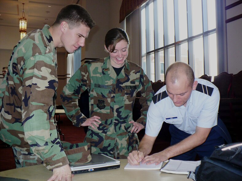 2nd Lt. Corey Alfred, 1st Special Operations Civil Engineer Squadron, and 1st Lt. Eric Zimmerman, 689 Armament Systems Squadron Test Engineer, Eglin Air Force Base, answer questions for an Air Force Reserve Officer Training Corps cadet at the Florida State University AFROTC Career Day Jan. 24. Fifteen Airmen from Hurlburt Field and Eglin AFB gave presentations for the cadets and answered questions about their career fields. (U.S. Air Force photo/2nd Lt. Lauren Johnson)