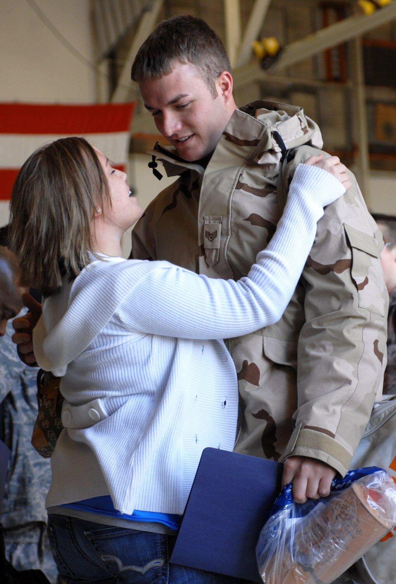 MOUNTAIN HOME AIR FORCE BASE, Idaho -- Senior Airman Eugene Haffner, 726th Air Control Squadron, is greeted by his wife for the first time after four months, Jan 23. The Airmen served at different locations within Iraq since September 2007 in support of Operation Iraqi Freedom. While deployed, their mission was to monitor the airspace over the battlefield and provide military leaders with a clear and accurate “picture” of that area, allowing commanders to make informed, real-time decisions. (U.S. Air Force photo/ Airman 1st Class Ryan Crane)