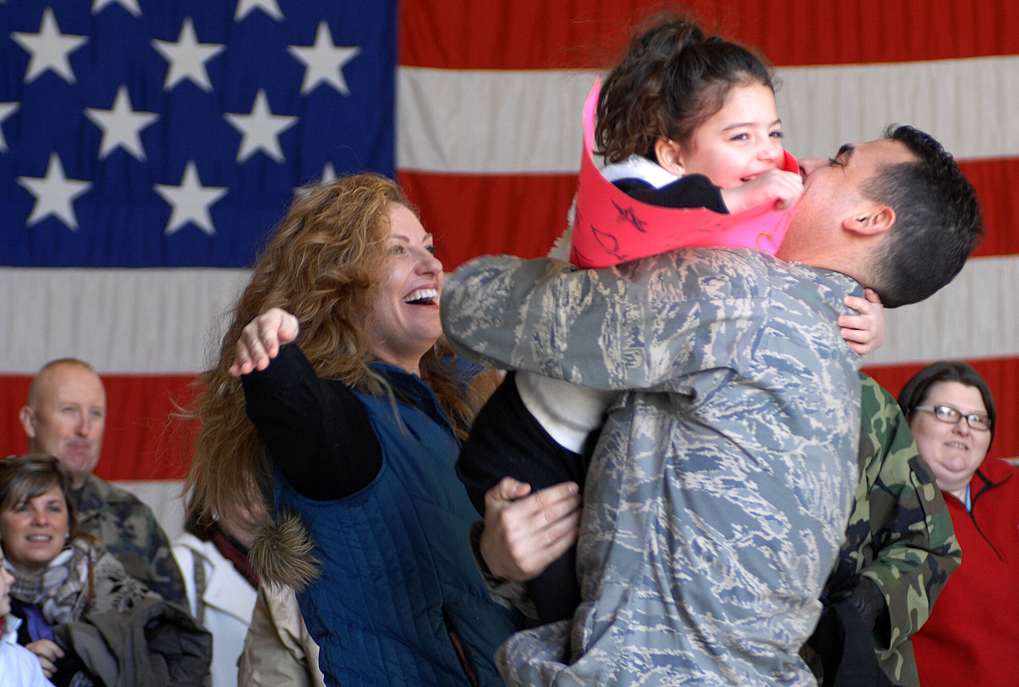 MOUNTAIN HOME AIR FORCE BASE, Idaho -- Capt. Joshua Hayburn, 726th Air Control Squadron, is greeted by his wife and daughter after returning from a four month deployment to Iraq, Jan 23. Captain Hayburn, along with nearly 190 other “Hardrockers” served at different locations within Iraq since September 2007 in support of Operation Iraqi Freedom. While deployed, their mission was to monitor the airspace over the battlefield and provide military leaders with a clear and accurate “picture” of that area, allowing commanders to make informed, real-time decisions. (U.S. Air Force photo/ Airman 1st Class Ryan Crane)