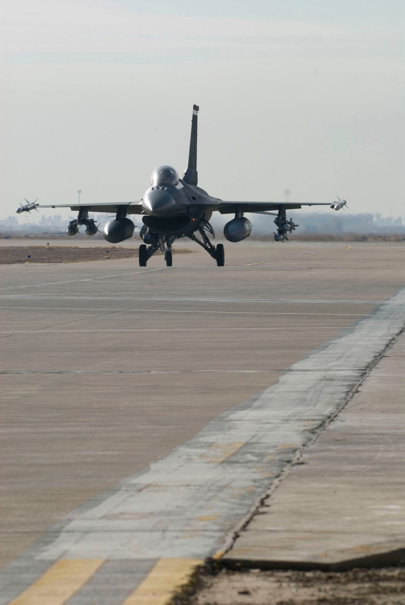 An F-16 Fighting Falcon from the 22nd Expeditionary Fighter Squadron taxis from the runway to a secure area to disarm Jan. 19 at Balad Air Base, Iraq. Munitions are de-armed prior to returning to a hardened aircraft shelter to ensure the safety of ground personnel.  (U.S. Air Force photo/Staff Sgt. Joshua Garcia)