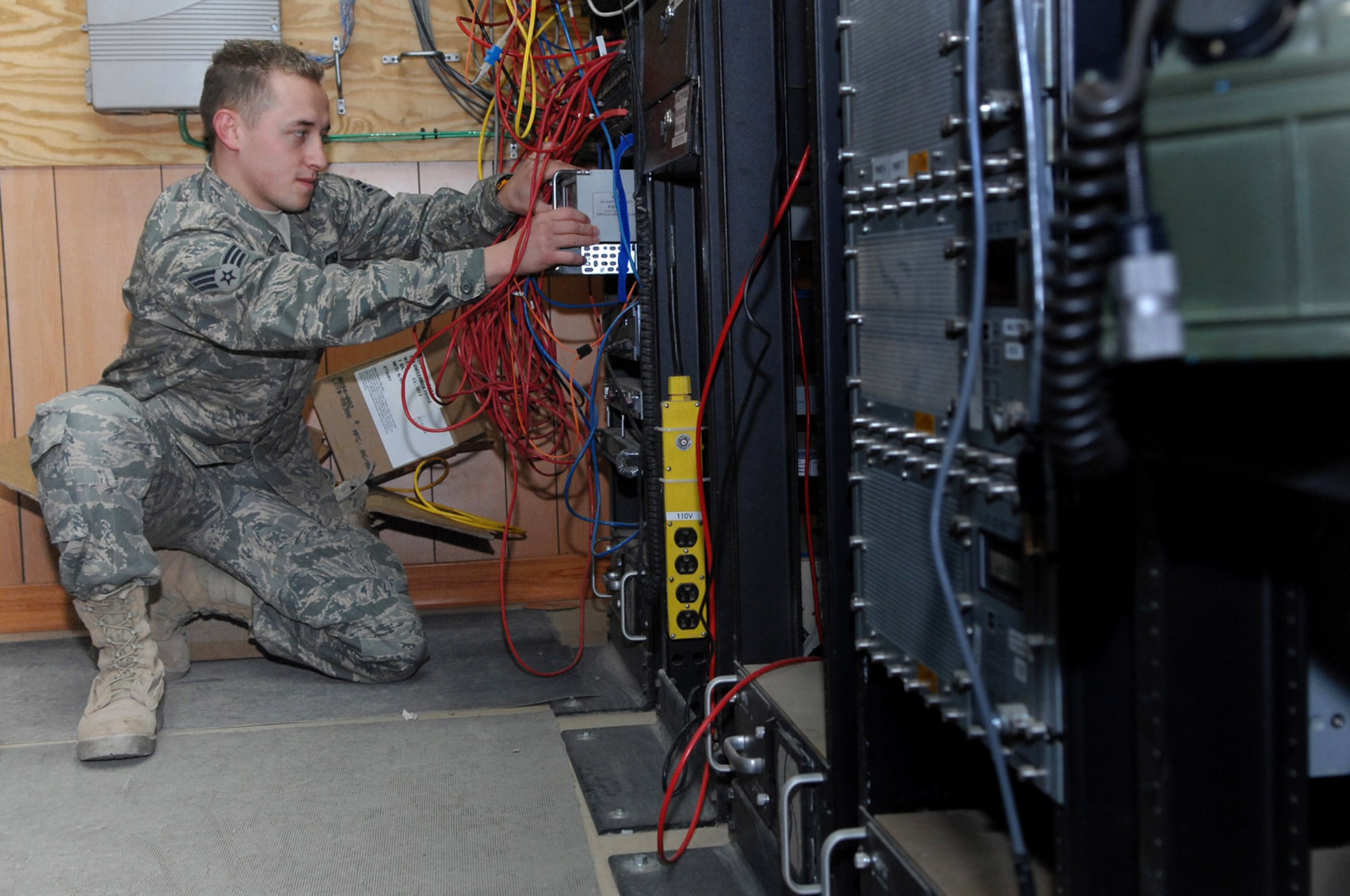 Senior Airman Zachary Felten configures an encryption device which receives unsecured signals and converts them to secure signals Jan. 22 at Balad Air Base, Iraq. Air Control Squadron communications Airmen maintain the systems that monitor combat air space. Airman Felten is a 727th Expeditionary Air Control Squadron tech controller deployed from Eglin Air Force Base, Fla. (U.S. Air Force photo/Senior Airman Julianne Showalter) 