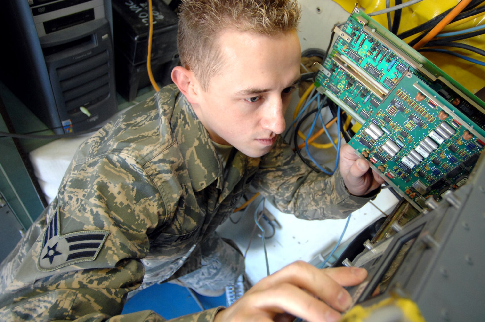 Senior Airman Zachary Felten trouble shoots an FCC-100 Jan. 22 which receives the radar feed air traffic controllers use Balad Air Base, Iraq. Air Control Squadron communications Airmen maintain the systems that monitor combat air space. Airman Felten is a 727th Expeditionary Air Control Squadron tech controller deployed from Eglin Air Force Base, Fla. (U.S. Air Force photo/Senior Airman Julianne Showalter) 