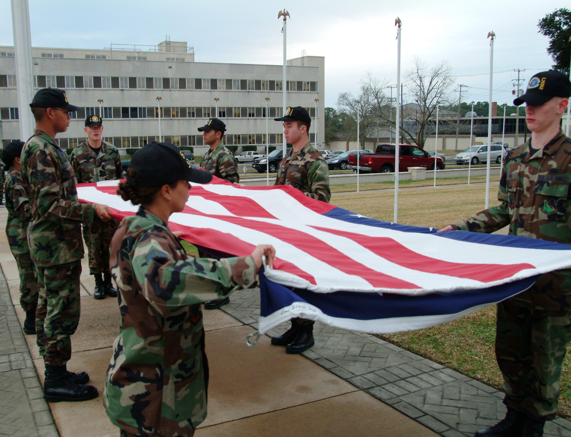 Members of the 53d Wing fold the base flag during a retreat ceremony at Eglin Air Force Base Jan. 24.  More than 135 members of the 53d came out for the ceremony.  Air Force photo by Staff Sgt. Samuel King Jr.