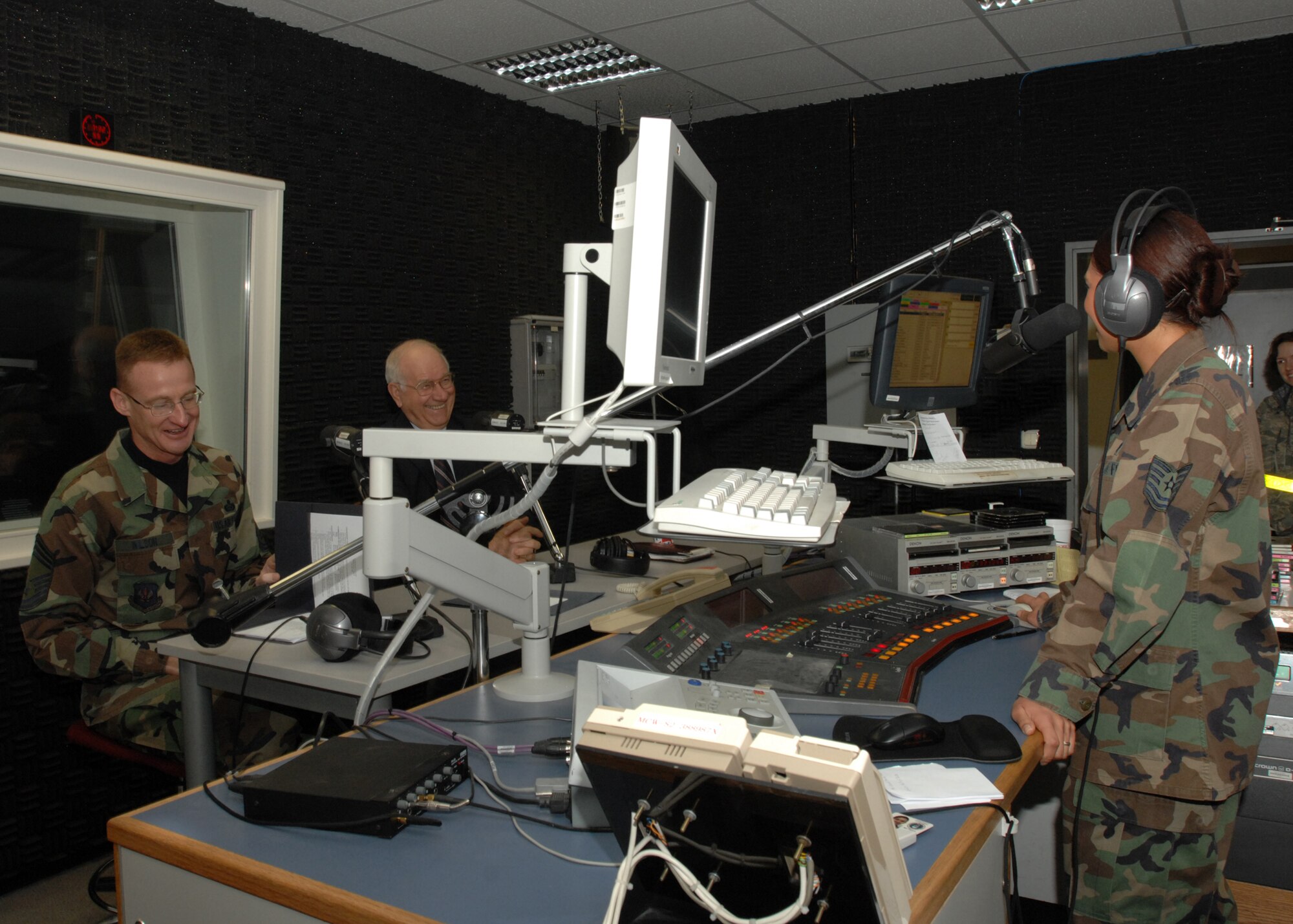 SPANGDAHLEM IAR BASE, Germany – Tech. Sgt. Szu-Moy Ruiz, Detachment 9, Air Force News Agency broadcaster, conducts a radio interview with retired Chief Master Sgt. of the Air Force Sam Parish as Chief Master Sgt. Scott Wilson, 52nd Mission Support Group superintendent, looks on Jan. 18, 2008. The studio was the first stop of the morning in a long day of public appearances for Chief Parish. (U.S. Air Force photo/Airman 1st Class Jenifer Calhoun)