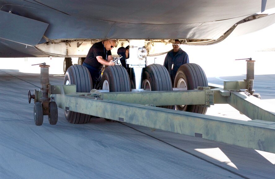 TSgt. Steven Markowski, SSgt. John Rosier, SSgt. Currean Smith, 653rd Combat Logistics Support Squadron prepare to tow a C-5. Courtesy photo; Edwards AFB