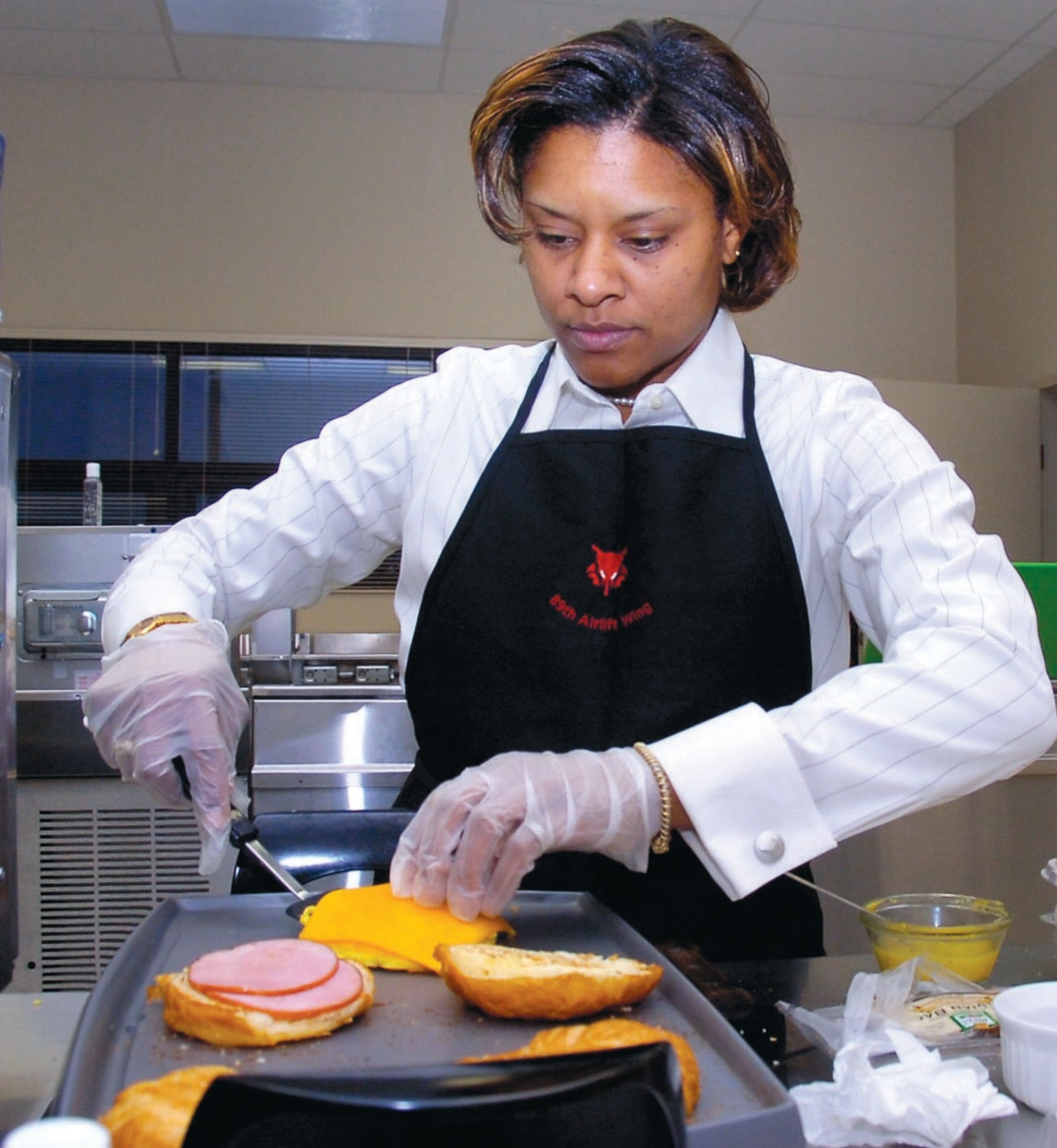 Master Sgt. Tangella Brown, Executive Airlift Training Center superintendant, whips up a take-out breakfast for pilots prior to their scheduled mission. (US Air Force/Bobby Jones)