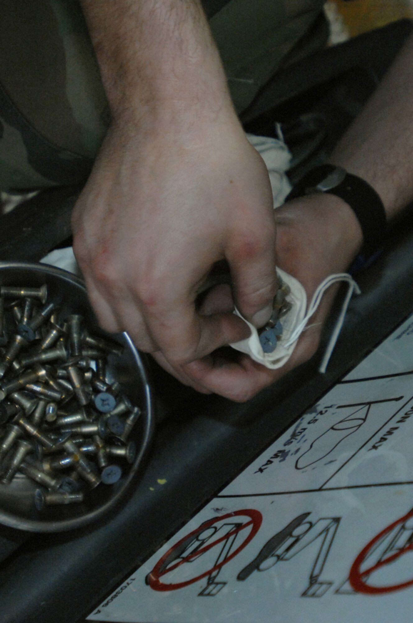 Senior Airman Tim Trujillo, 100th Maintenance Squadron crew chief, puts screws into a bag for maintenance on a KC-135 here Dec. 3, 2007. Every 15 months Airman Trujillo and others in the 12-person shop do a little heavier maintenance on the old tanker. (U.S. Air Force photo by Senior Airman Teresa M. Hawkins)