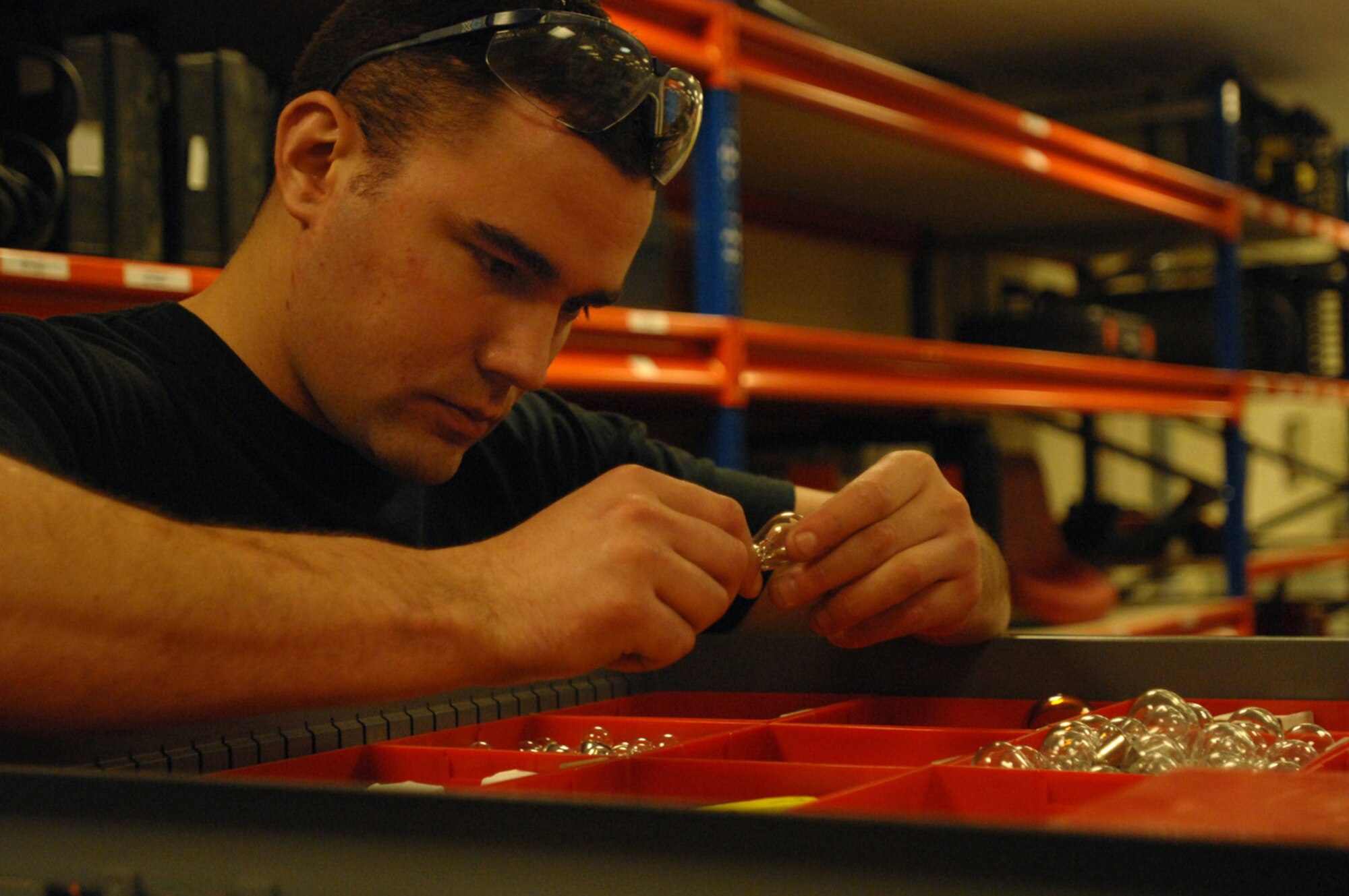 Senior Airman Tim Trujillo, 100th Maintenance Squadron crew chief, looks for a replacement bulb here Dec. 10, 2007. Every 15 months Airman Trujillo and others in the 12-person shop do a little heavier maintenance on the old tanker. (U.S. Air Force photo by Senior Airman Teresa M. Hawkins)