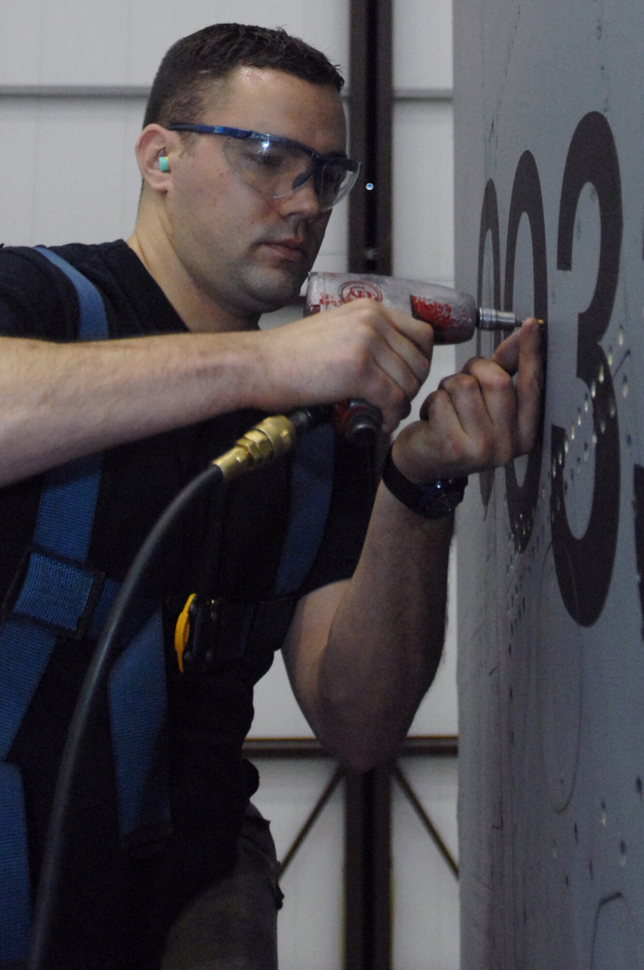 Senior Airman Tim Trujillo, 100th Maintenance Squadron crew chief, removes a panel from the tail of a KC-135 here Dec. 3, 2007. Every 15 months Airman Trujillo and others in the 12-person shop do a little heavier maintenance on the old tanker.(U.S. Air Force photo by Senior Airman Teresa M. Hawkins)