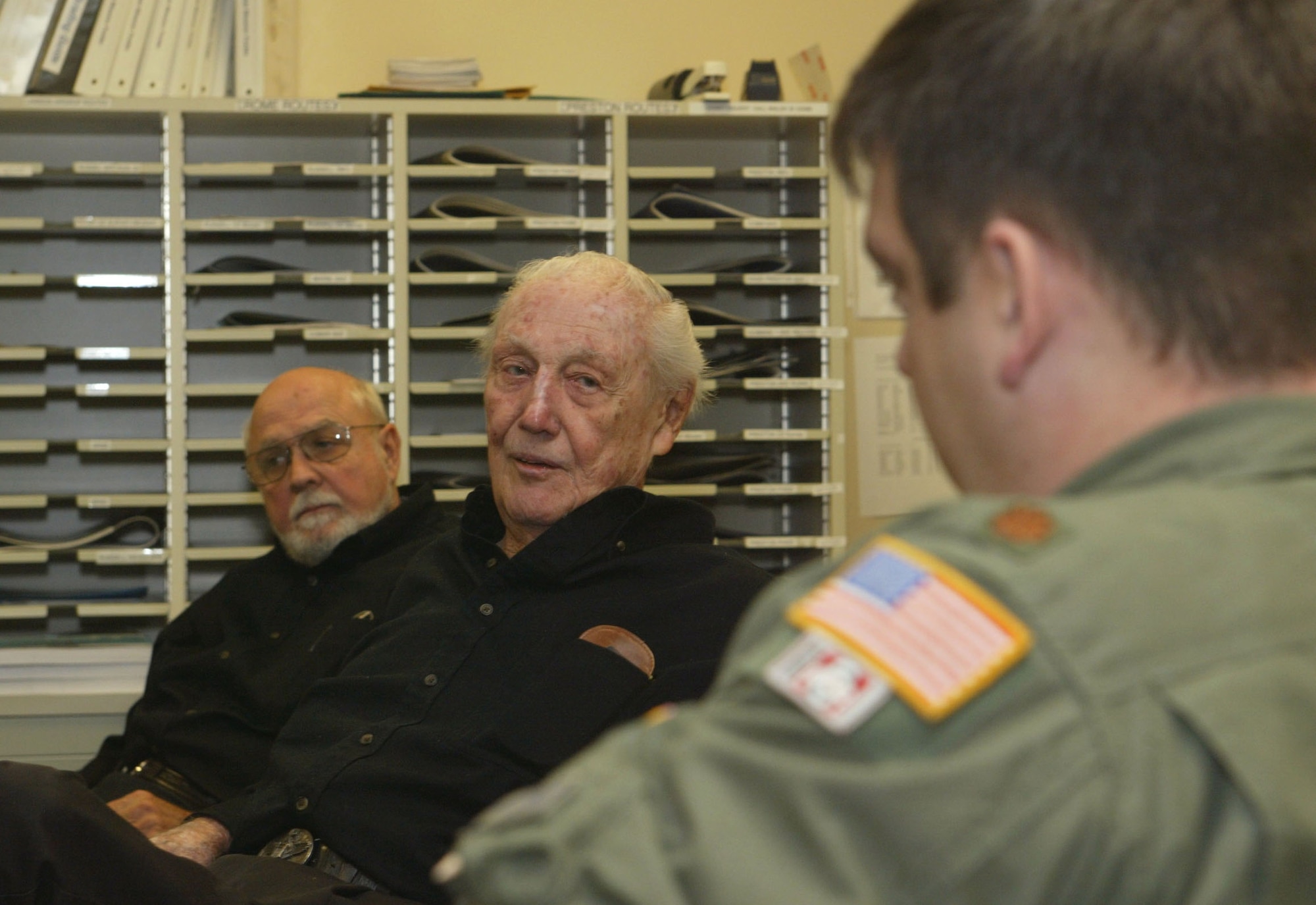 Retired Air Force Col. Harold "Hal" Weekley (center) is the author of "The Last Combat B-17 Driver." He recently visited and spoke to the Airmen in the 700th Airlift Squadron as part of their Air Warrior series of speakers. The program is meant to inspire and foster the warrior spirit in squadron members. 