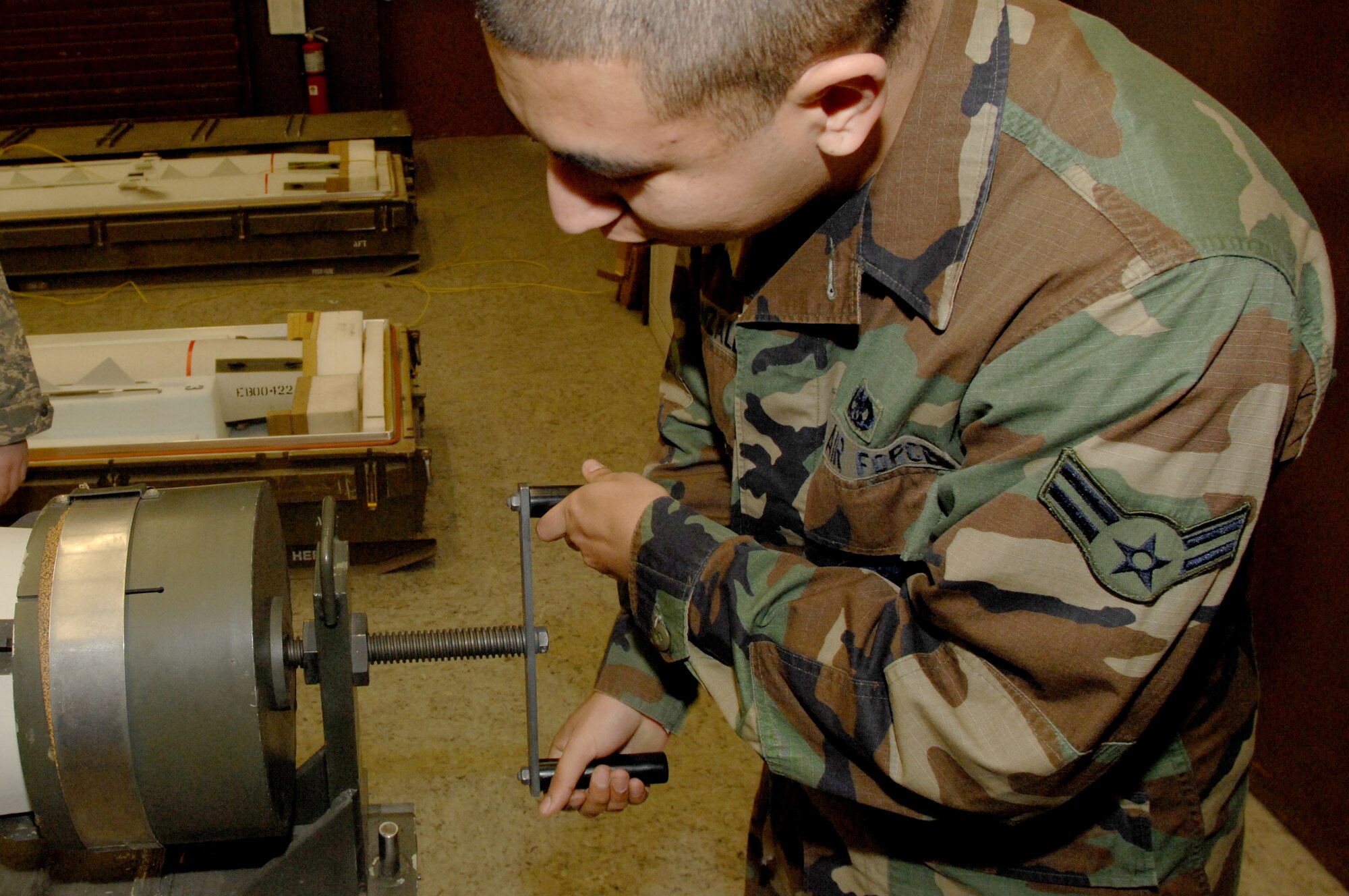 Airman 1st Class Ivan Gonzalez, 435th Munitions Squadron, adjusts the compression adapter on the Air-to-Ground Missile-88 High-speed Anti-Radiation Missile Jan. 23 at Ramstein Air Base.  The AGM-88 HARM is now going to be inspected every five years instead of ten.  The missiles are old and have a higher failure rate.  (U.S. Air Force photo/ Airman 1st Class Amber Bressler)(RELEASED)