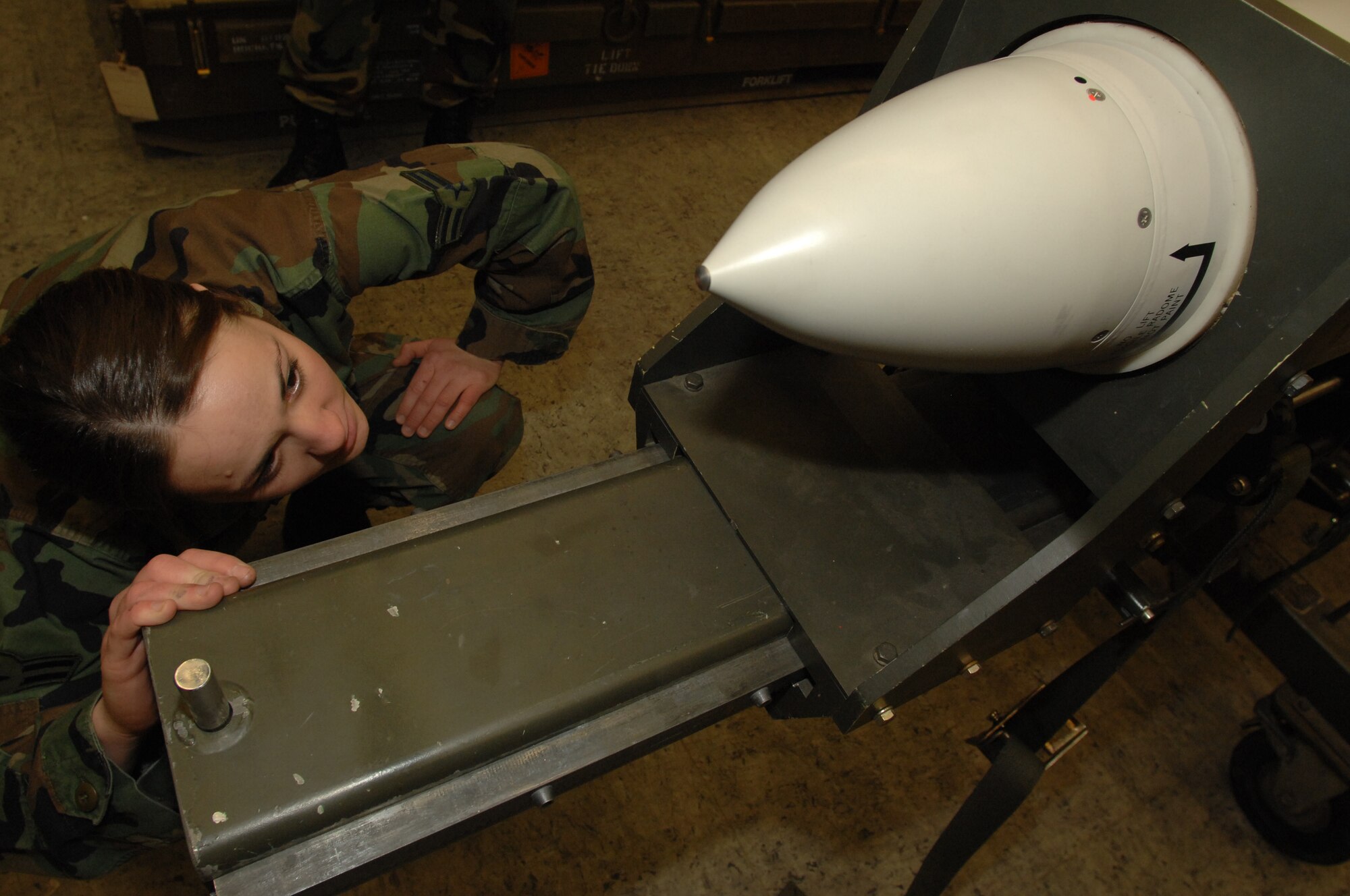 Airman 1st Class Brandie Brown, 435th Munitions Squadron, visually inspects the Air-to-Ground Missile-88 High-speed Anti-Radiation Missile radome for scratches, nicks and pitting Jan. 23 at Ramstein. (U.S. Air Force photo/ Airman 1st Class Amber Bressler)(RELEASED)

