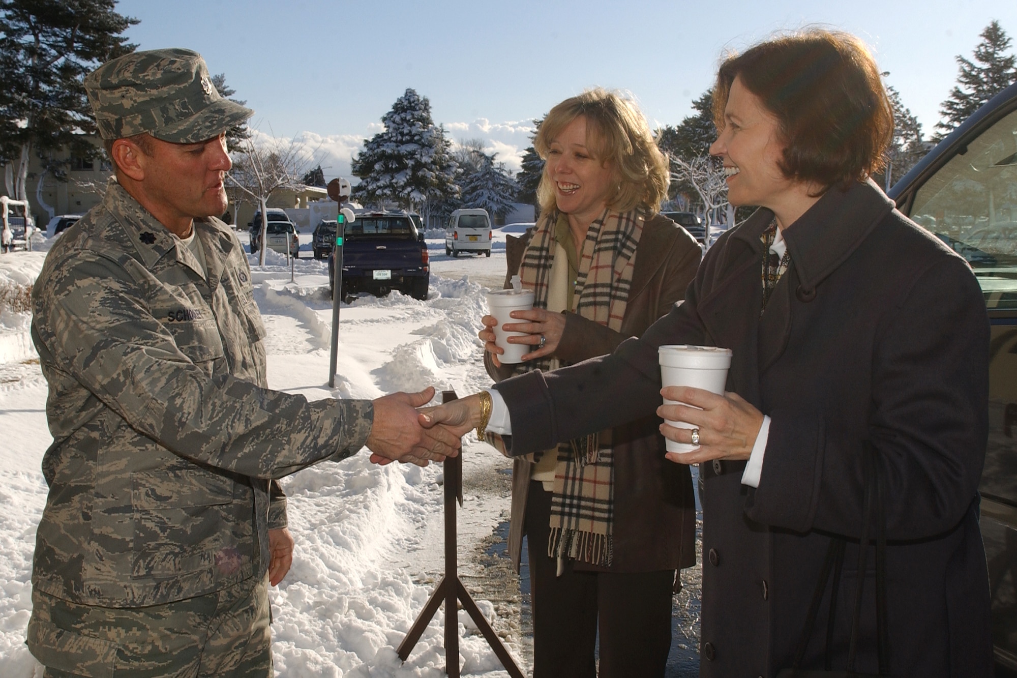MISAWA AIR BASE, Japan -- Lt. Col. Brian Schooley, 35th Mission Support Squadron commander, meets Mrs. Donna O'Shaughnessy and Mrs. Eva-Marie Chandler, the wives of the 35th Fighter Wing commander and the Pacific Air Forces commander respectively, as he escorts them to the Airman and Family Readiness Center here Jan. 25, 2008.  General and Mrs. Chandler were here on a two-day visit to familiarize themselves with Misawa Air Base.  (U.S. Air Force photo by Senior Airman Robert Barnett)