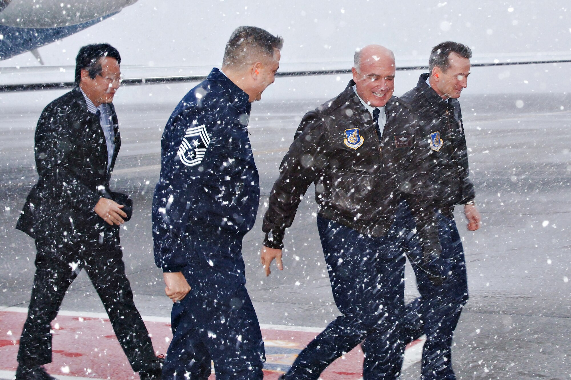 MISAWA AIR BASE, Japan -- Gen. Howie Chandler (center), Pacific Air Forces commander, is greeted by Col. T.J. O'Shaughnessy (right), 35th Fighter Wing commander, and Command Chief Master Sgt. Ricky Price, 35th FW, as he arrives here Jan. 24, 2008.  This was General Chandler's first visit to Misawa since taking command of the Pacific Air Forces in November 2007.  (U.S. Air Force photo by Airman 1st Class Benjamin Wilson)
