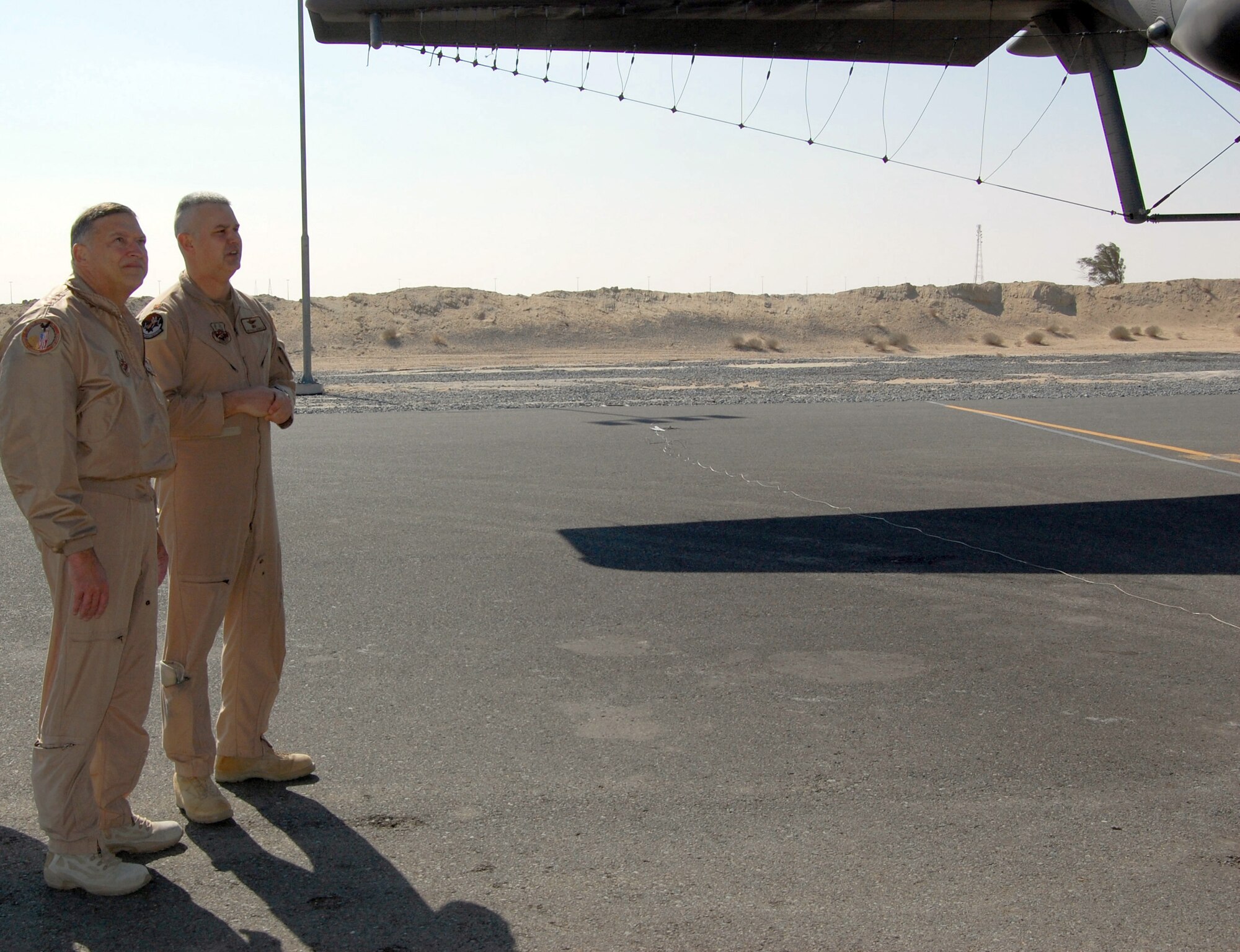 Major Michael Arnold, 43rd Expeditionary Electronic Combat Squadron, describes the capabilities of the EC-130H Compass Call to Lt. Gen. Gary L. North, 9th Air Force and Central Command Air Forces commander, Jan. 24 at a flight line in the Persian Gulf region.  The E-C130H Compass Call system employs offensive counterinformation and electronic attack capabilities supporting U.S. and Coalition tactical air, surface, and special operations forces. (U.S. Air Force photo/ Capt. Jason McCree) 