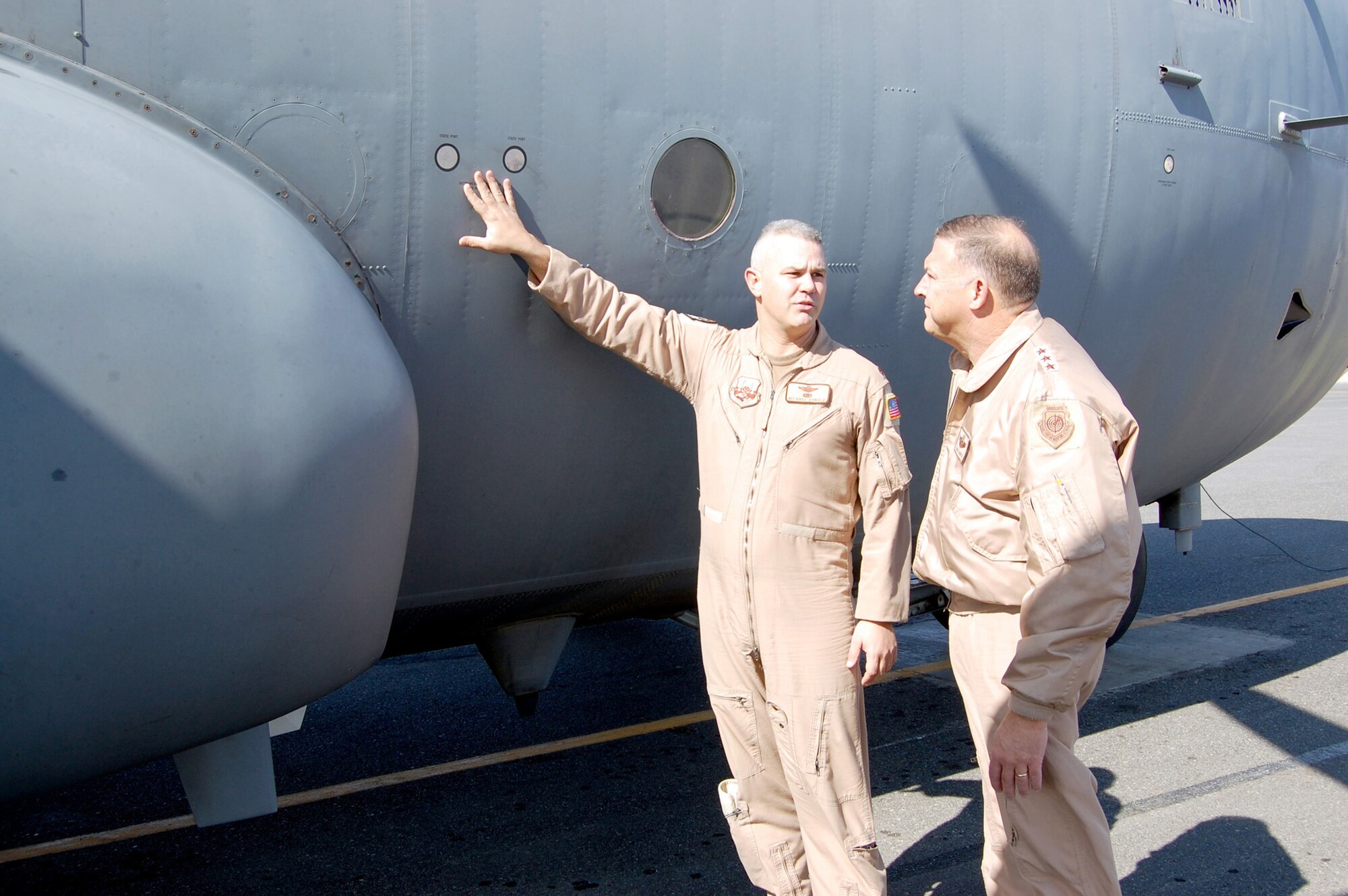 Major Michael Arnold, 43rd Expeditionary Electronic Combat Squadron, describes the capabilities of the EC-130H Compass Call to Lt. Gen. Gary L. North, 9th Air Force and Central Command Air Forces commander, Jan. 24 at a flight line in the Persian Gulf region.  The E-C130H Compass Call system employs offensive counterinformation and electronic attack capabilities supporting U.S. and Coalition tactical air, surface, and special operations forces. (U.S. Air Force photo/ Capt. Jason McCree) 