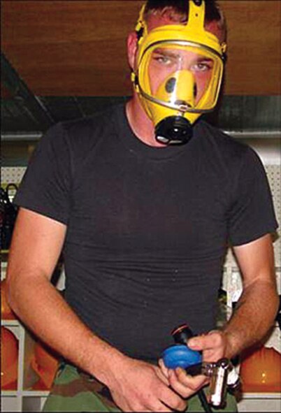 Senior Airman Zebulan Tune, 18th Civil Engineer Squadron liquid fuels maintenance, demonstrates the function of a protective respirator during a confined space entry in last year’s Environmental, Safety and Occupational Health Compliance Assessment and Management Program inspection. Showing the importance of safety equipment conveys the message of operational risk management and ensures all personnel are safe on the job. (Air Force photo/TSgt Jose Parra)