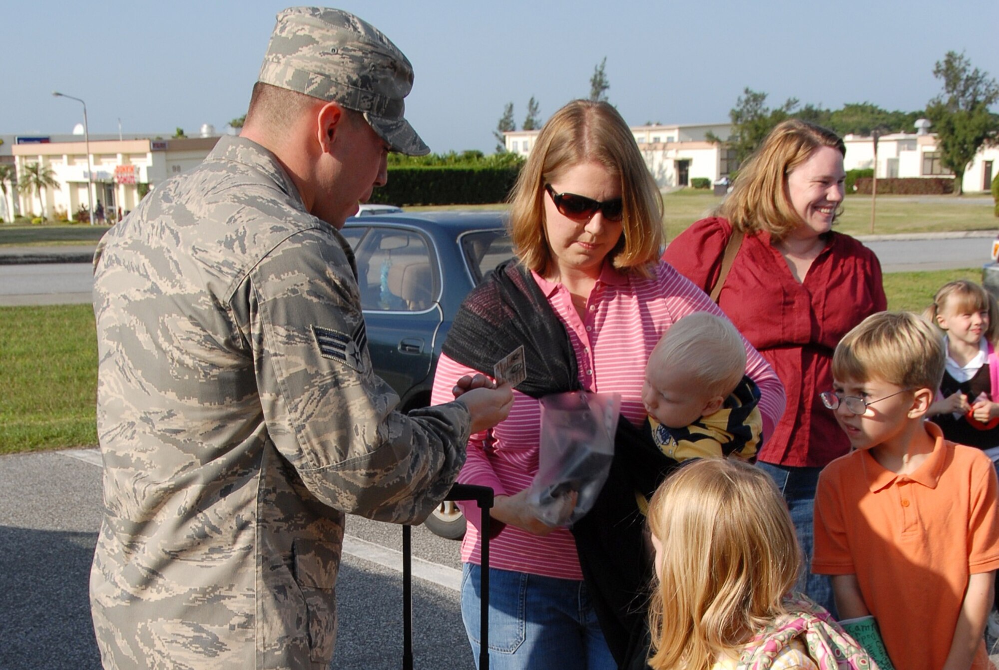 Senior Airman Joshua Alvarado, 18th Equipment Maintenance Squadron, checks the ID and passport of an evacuee during a PACAF IG inspection of non-combatant evacuation operation procedures at Kadena Air Base, Japan, Jan. 19, 2007.  The 18th Wing exercise from Jan. 18 to 20 tested the wing's ability to evacuate families during emergency situations.    (U.S. Air Force photo/Tech. Sgt. Anthony Iusi)